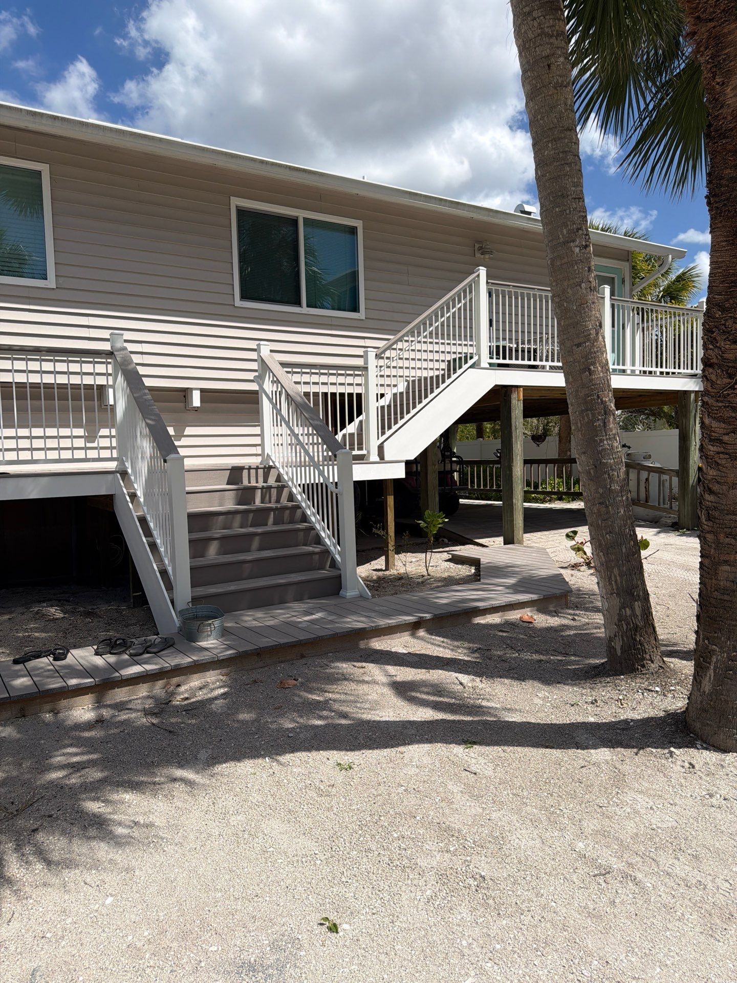 Elevated Home Deck Reconstruction With White Aluminum Railings in Placida by Smirnov Construction Inc