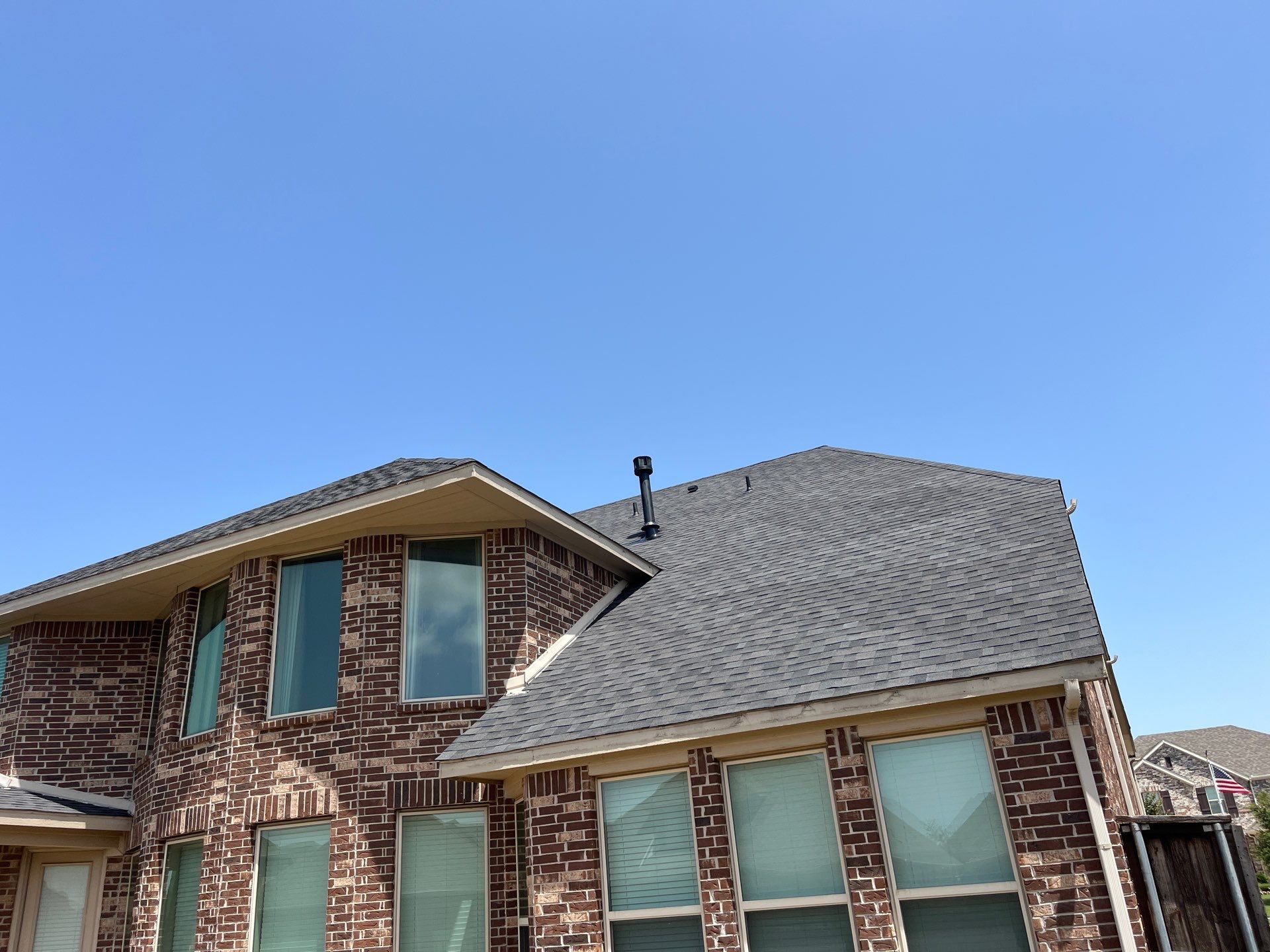 IKO Glacier-Brown Brick house by Tejas Roofworks + Restoration