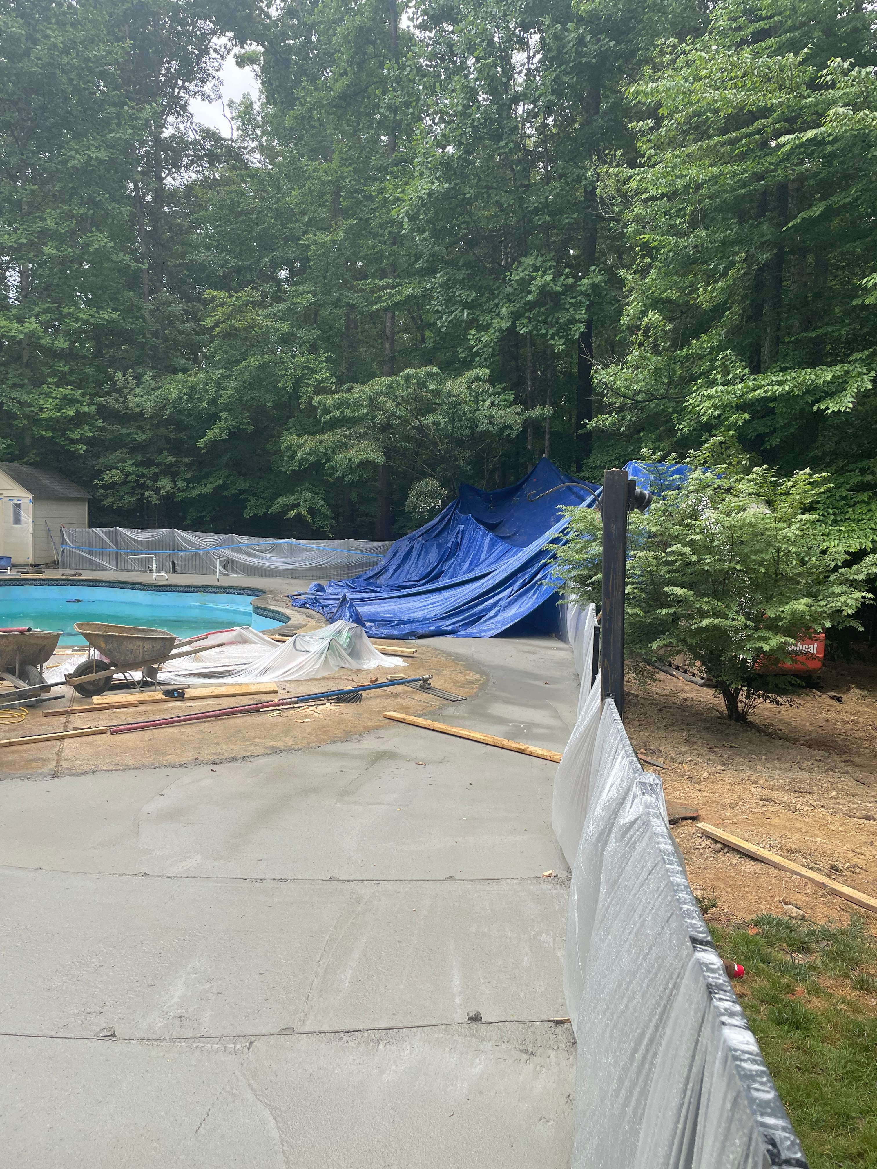 Pool Surround remodel with retaining walls, new waterfall and water slide by Fairfax Contractors, LLC
