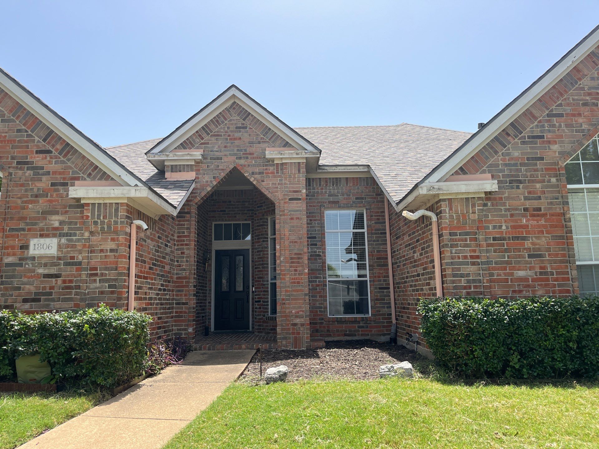 Red brick with IKO Cornerstone  by Tejas Roofworks + Restoration