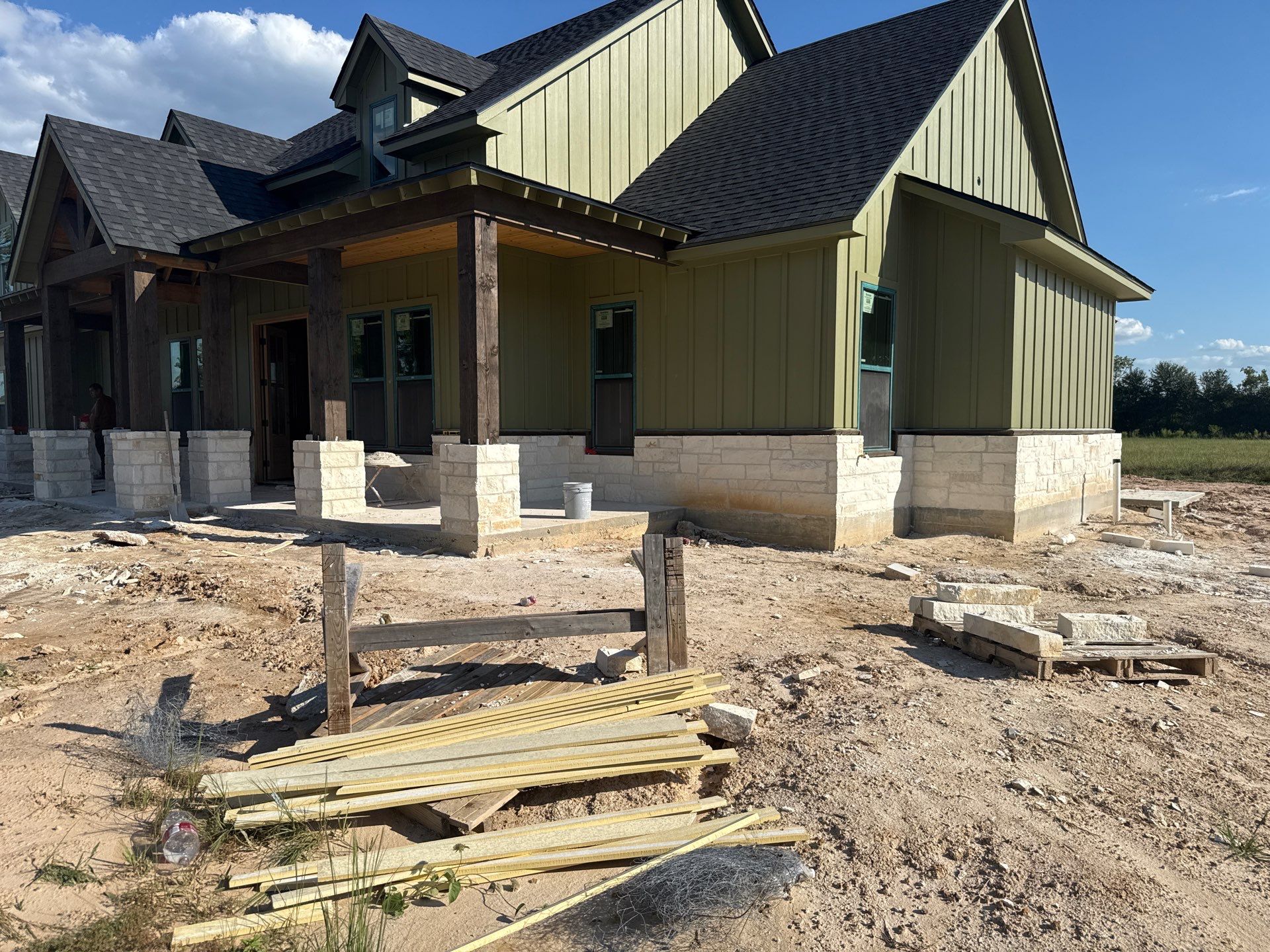 Cleveland Ranch Charm: Natural Stone Wainscot with Green Accent Siding. by Apex Conventional Stucco Llc