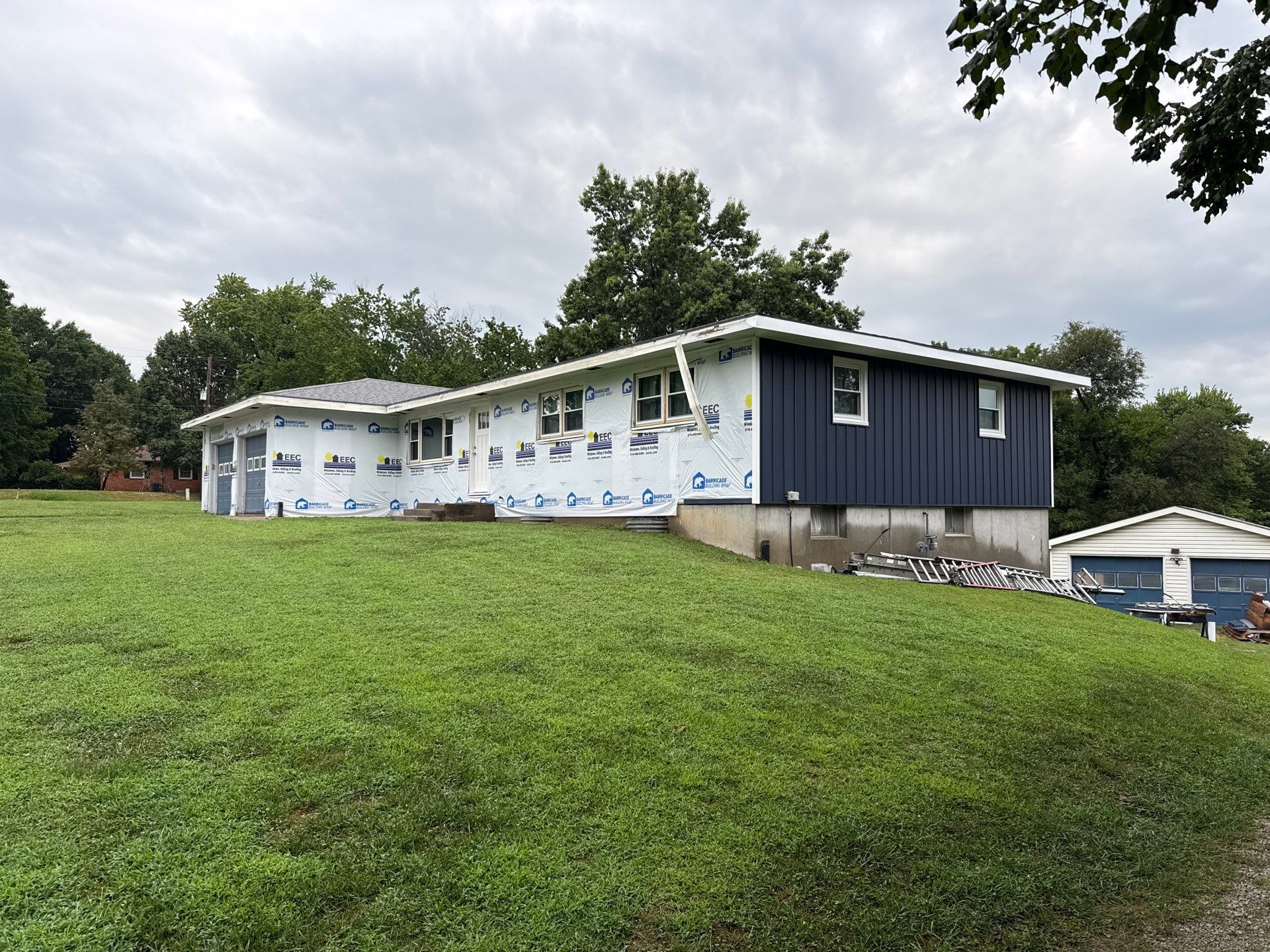 Indigo Board and Batten Siding and Window Replacement in Smithville by EEC Windows, Siding & Roofing