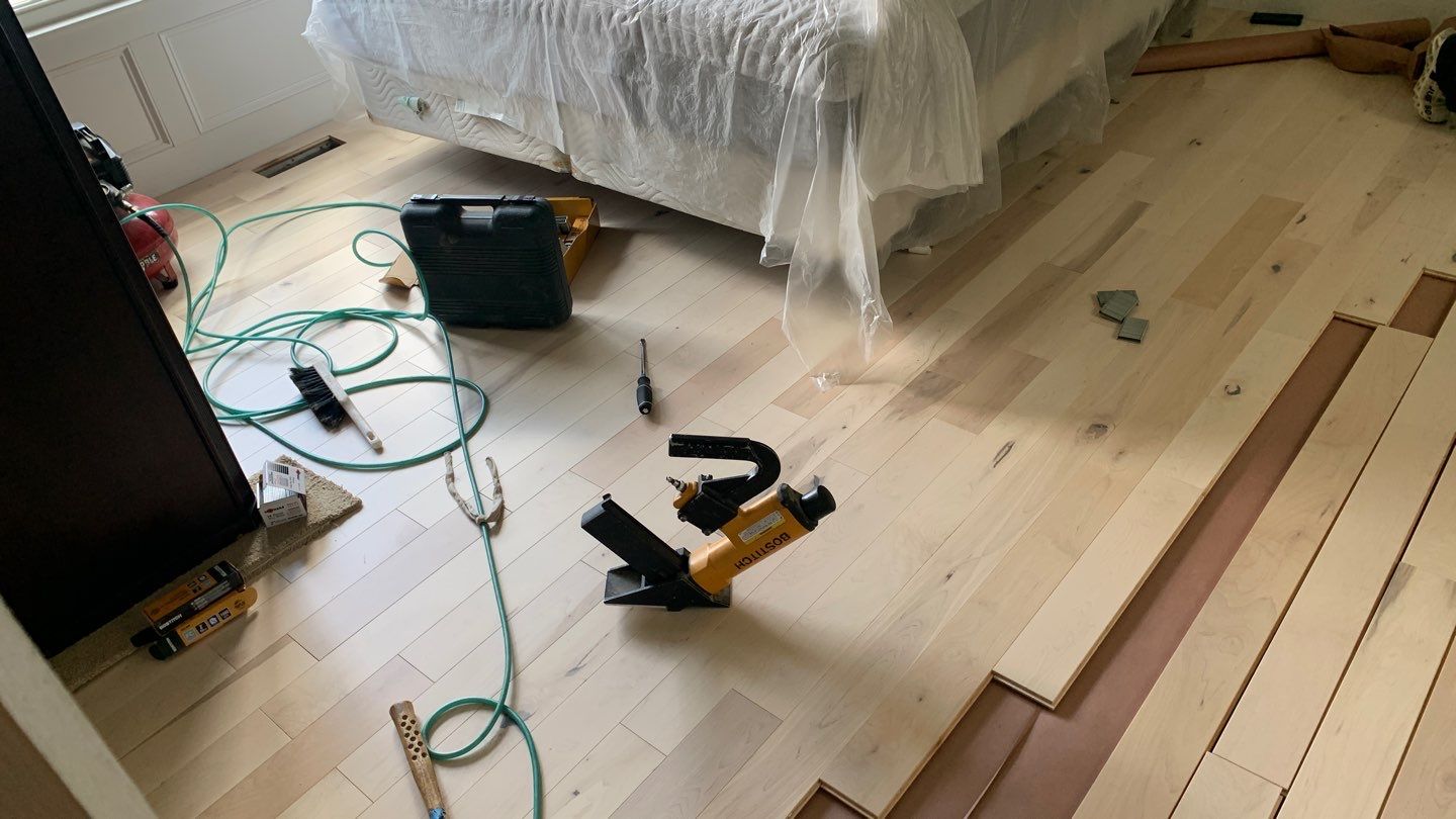 Flooring Installation using Maple Hardwood by Greenspring Construction Services