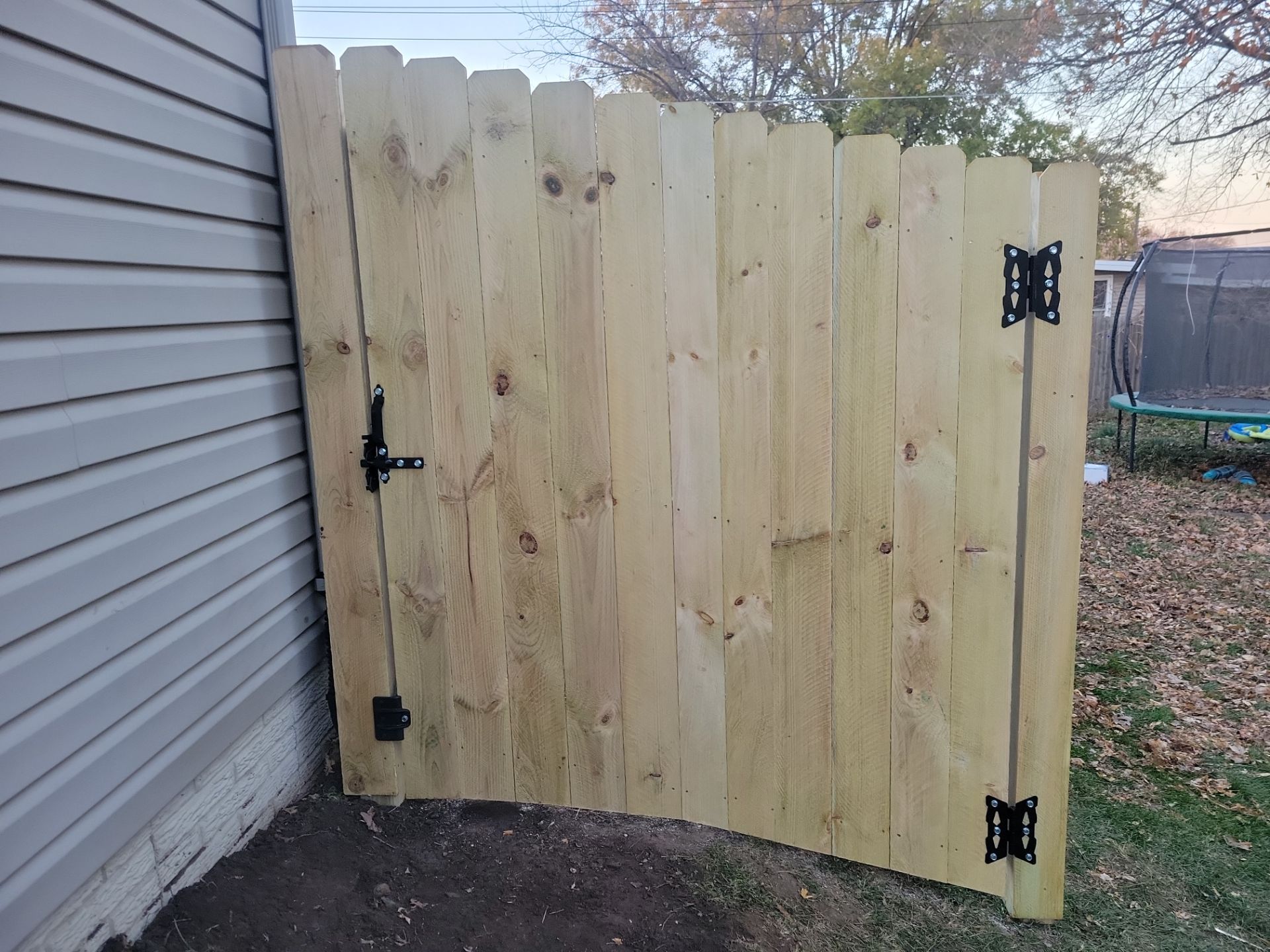 New Pressure-Treated Wood Privacy Fence and Gate in Charles City by Perfect Picket Fence and Stain
