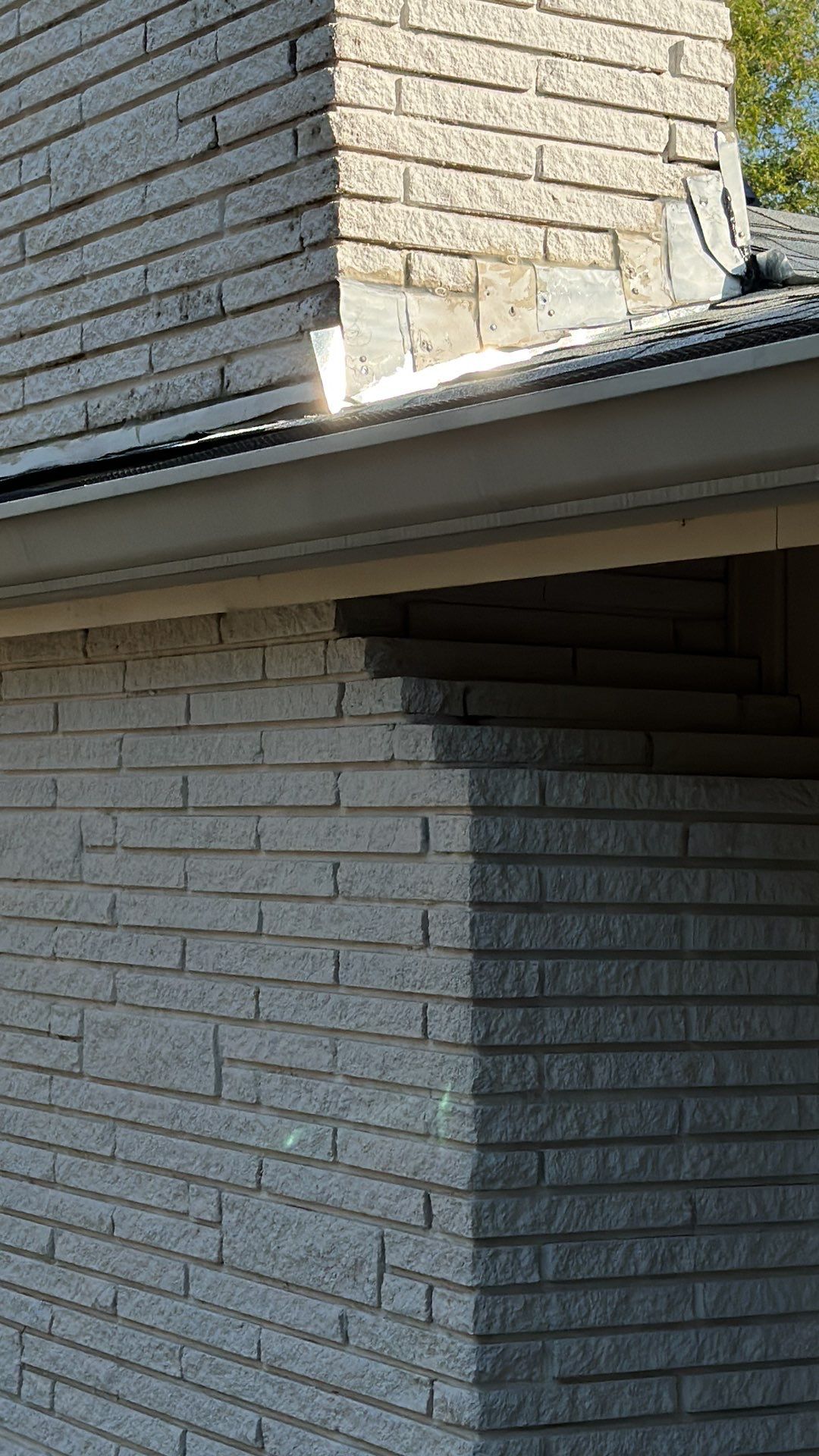 White siding/white brick chimney with Malarkey Silverwood by Tejas Roofworks + Restoration