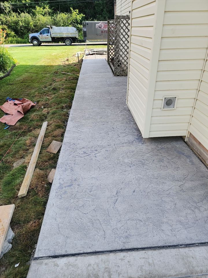 Stamped Concrete, Entry Door, and Concrete  by Ivy Lea Construction