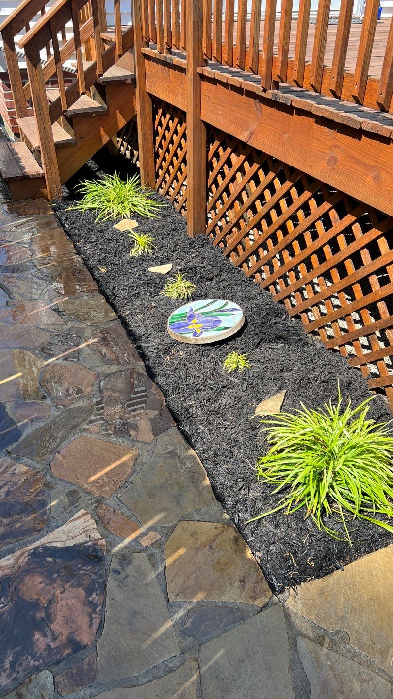 Liriope grasses, mulch and stone pavers by GrassBusters, Inc.