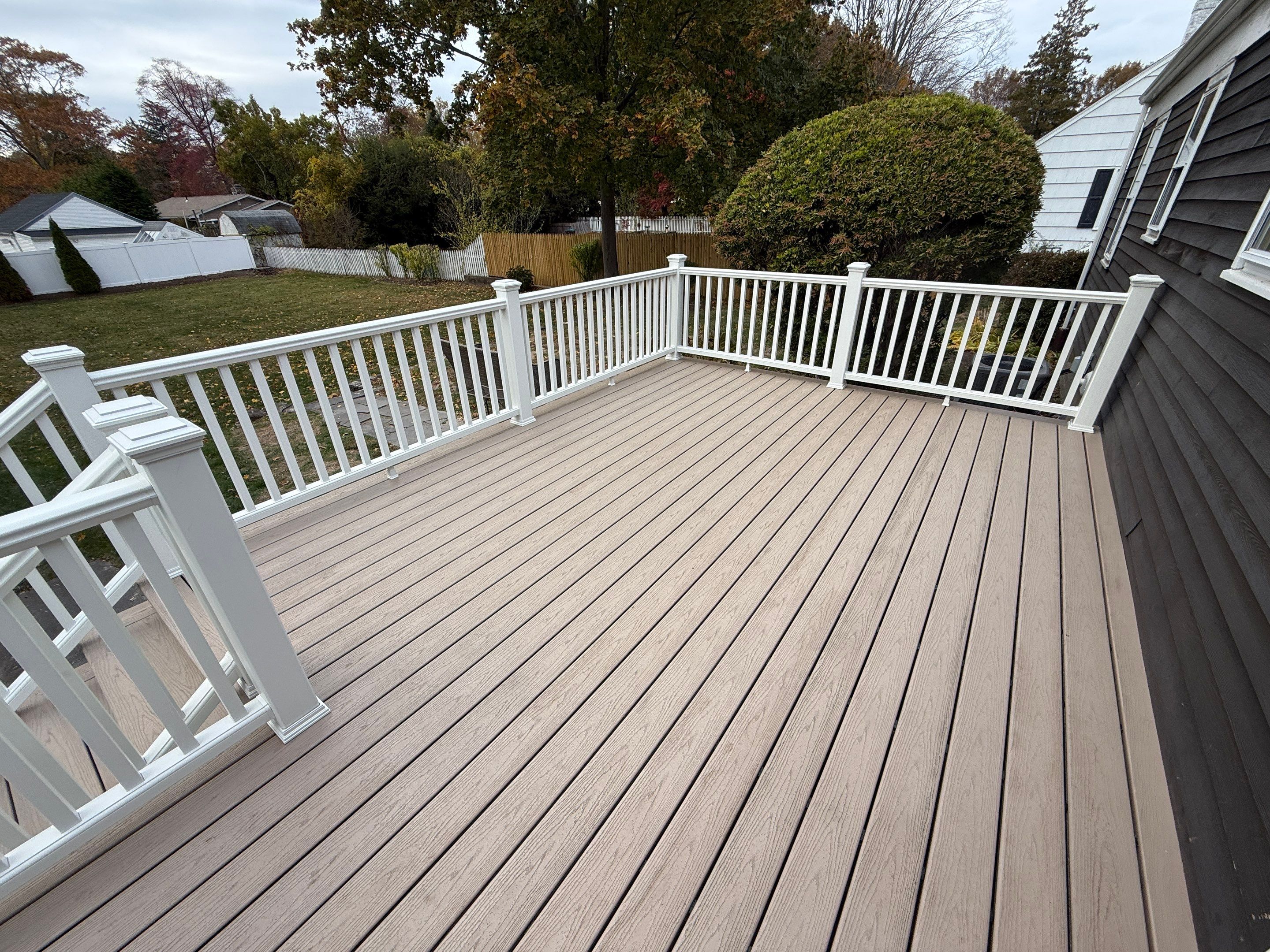 Deck replacement, using Trex Transcend Rope Swing, Transcend railings with ada graspable handrail. in white. by DiGiorgi Roofing and Siding Inc