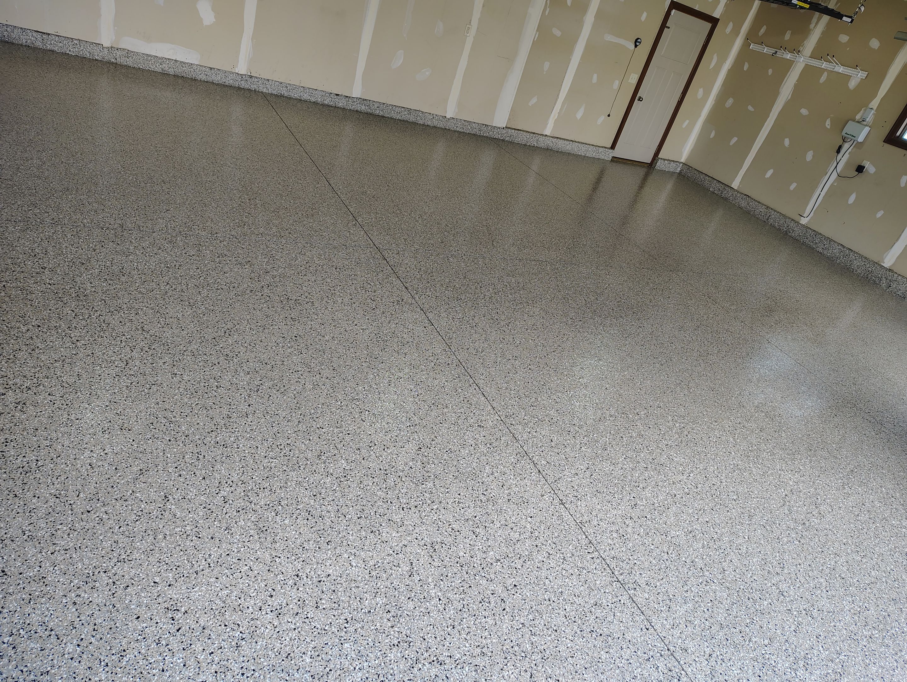 Multi-Car Garage Concrete Coating and Epoxy Finish in Sioux Falls by Select Painting, Coatings & Garage Cabinets