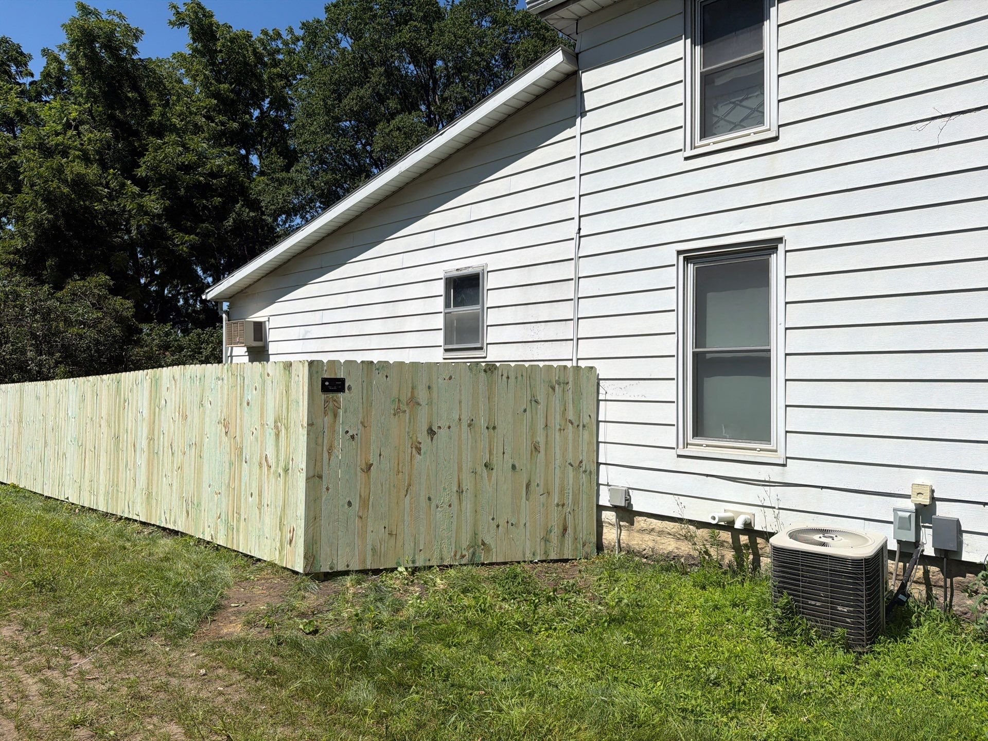 Pressure-Treated Wood Privacy Fence Installation in Waterloo by Perfect Picket Fence and Stain