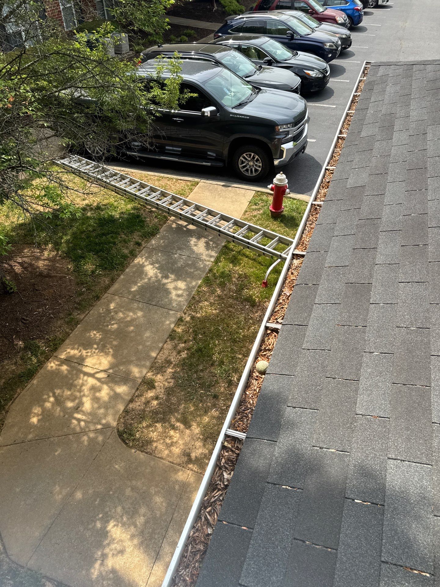 Commercial gutter cleaning Burlington / Mebane before photo with filled gutters