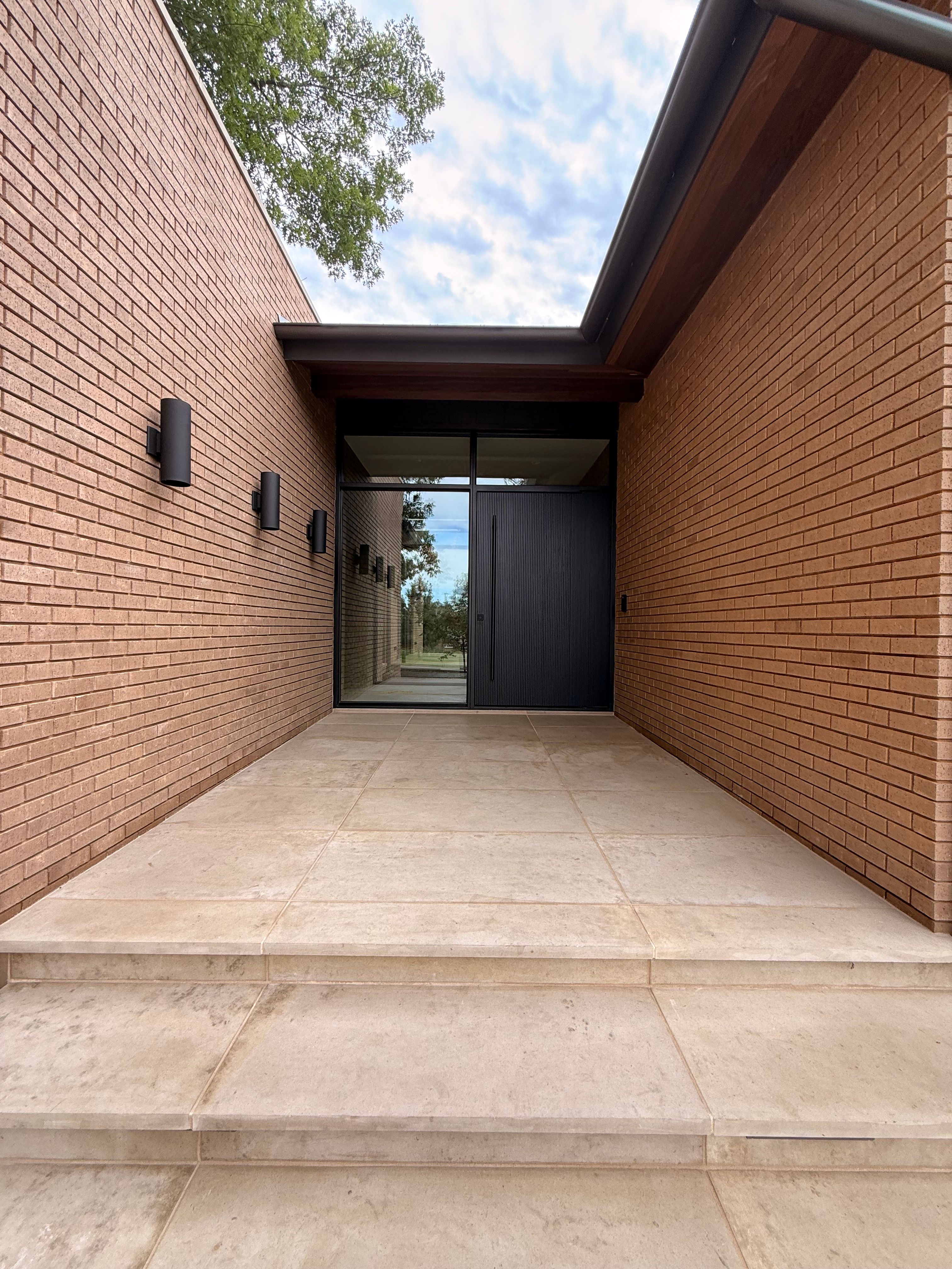 Custom Steel Oporto Pivot Door Installation for Dallas New Construction by Solara Custom Living