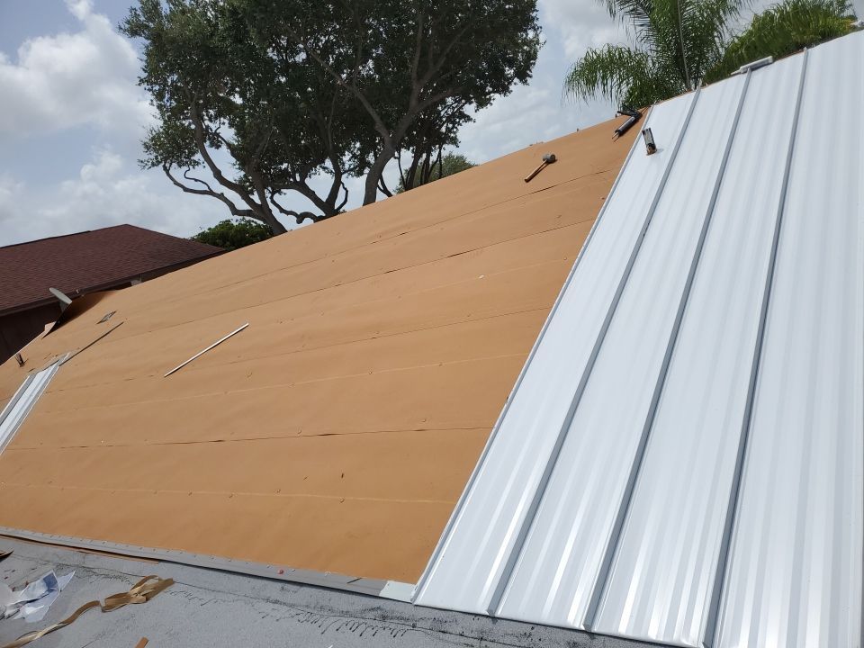 Residential Roofing Installation using 1.5" Nail Strip 24ga Solar White Kynar Coated Standing Seam Metal Panels by Morton Roofing, Inc.