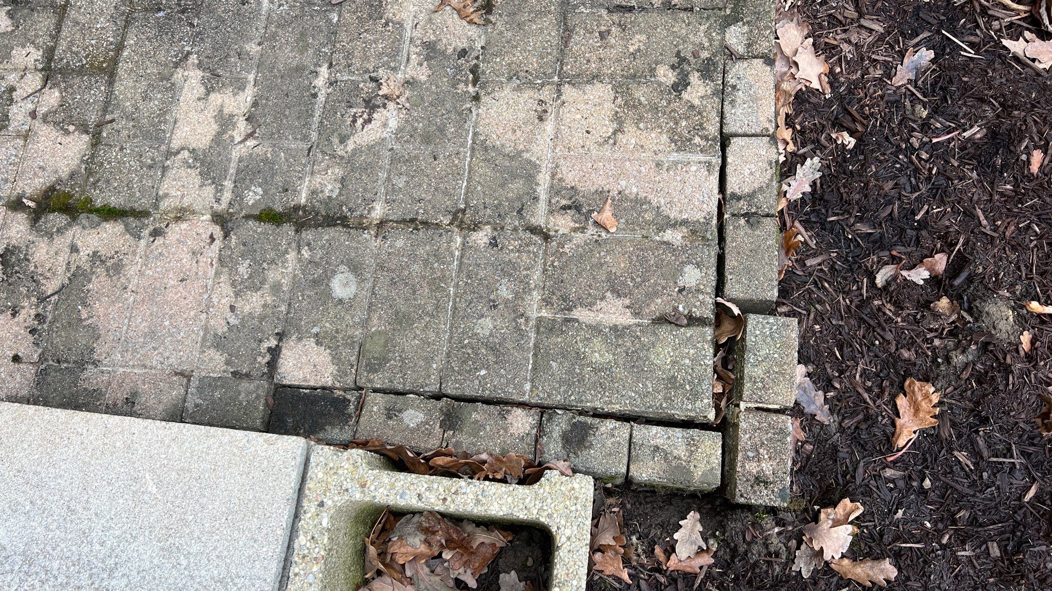 Gravel Creek Bed Installation and Paver Overlay Repair by Reisenberg’s Lawn & Landscape, LLC