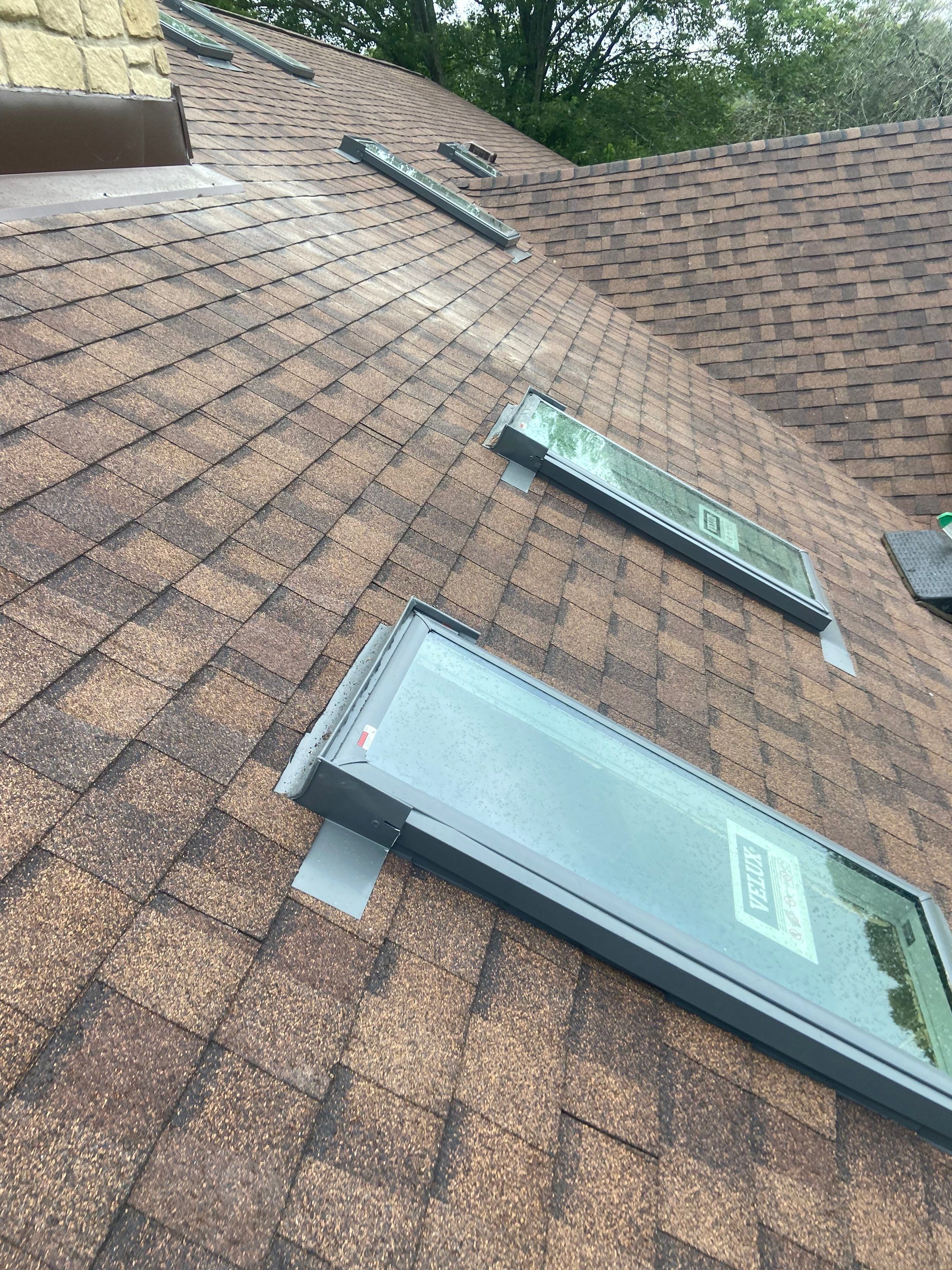 Shingle Roofing with Velux Skylight replacement and stone chimney flashing by Secure Construction Company Inc