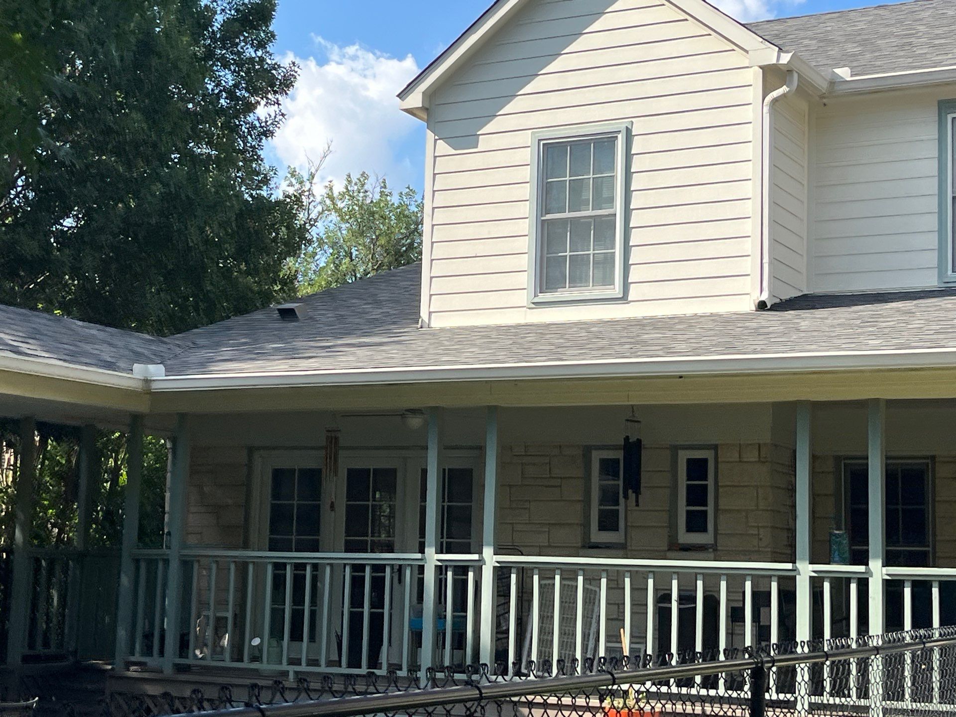 White brick with Malarkey Storm Grey by Tejas Roofworks + Restoration