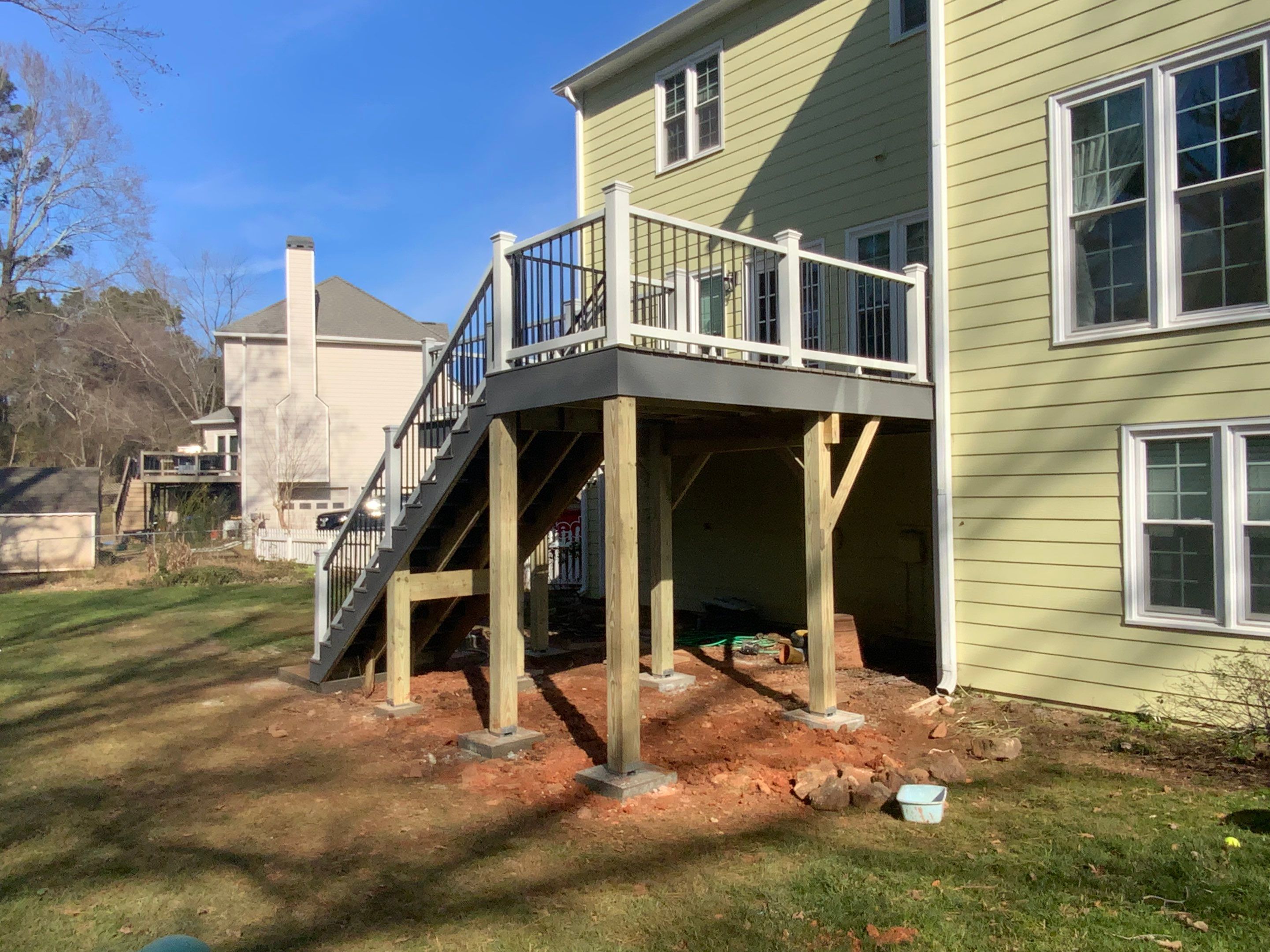 Elevated Grey Composite Deck Installation in Woodstock, Georgia by Swift Home Renovations
