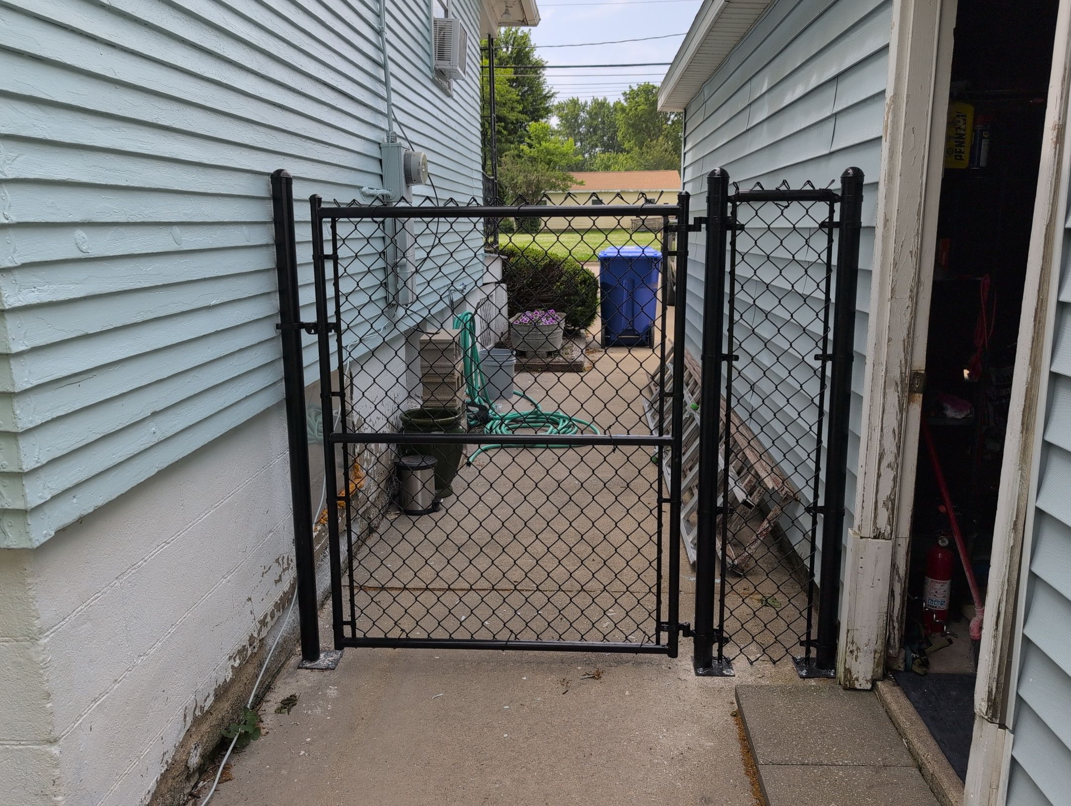 Black Vinyl Coated Chain Link Fence Installation in Independence by Perfect Picket Fence and Stain