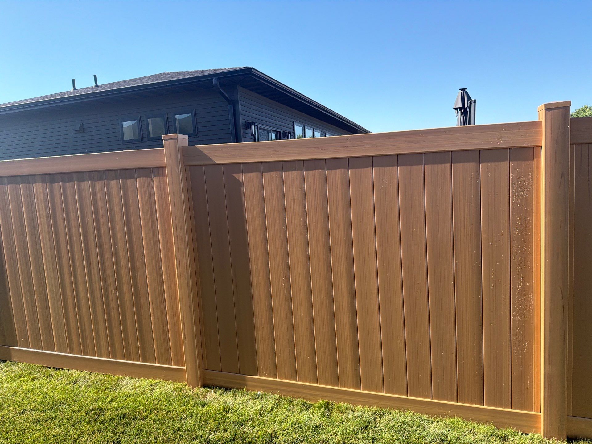 Residential Cypress Vinyl Privacy Fence Installation in Cedar Falls by Perfect Picket Fence and Stain