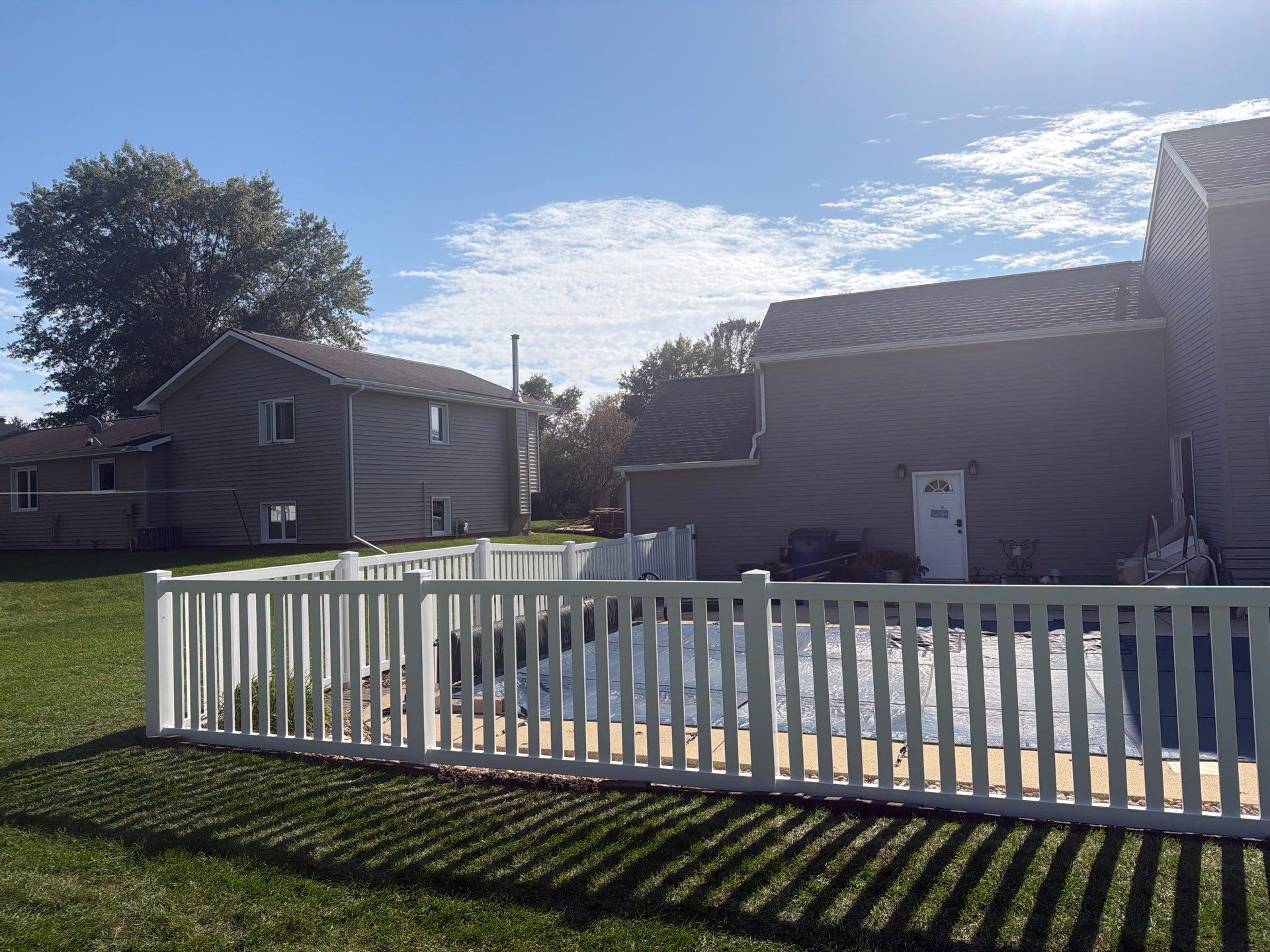 White Vinyl Picket Pool Fence Installation in Waterloo, Iowa by Perfect Picket Fence and Stain