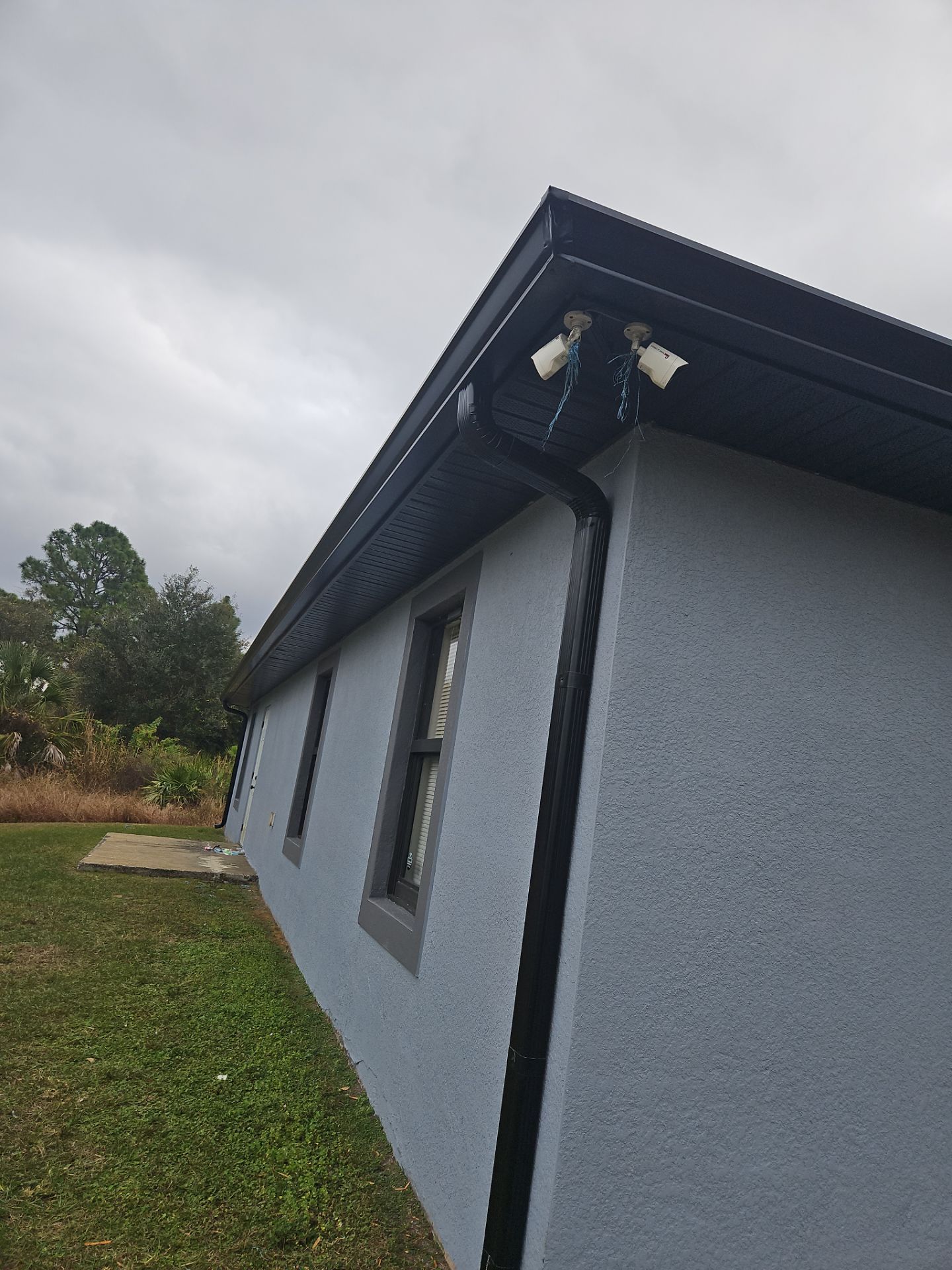 Black Seamless Gutters & Soffit/Fascia in Lehigh Acres FL by Gutter Professors