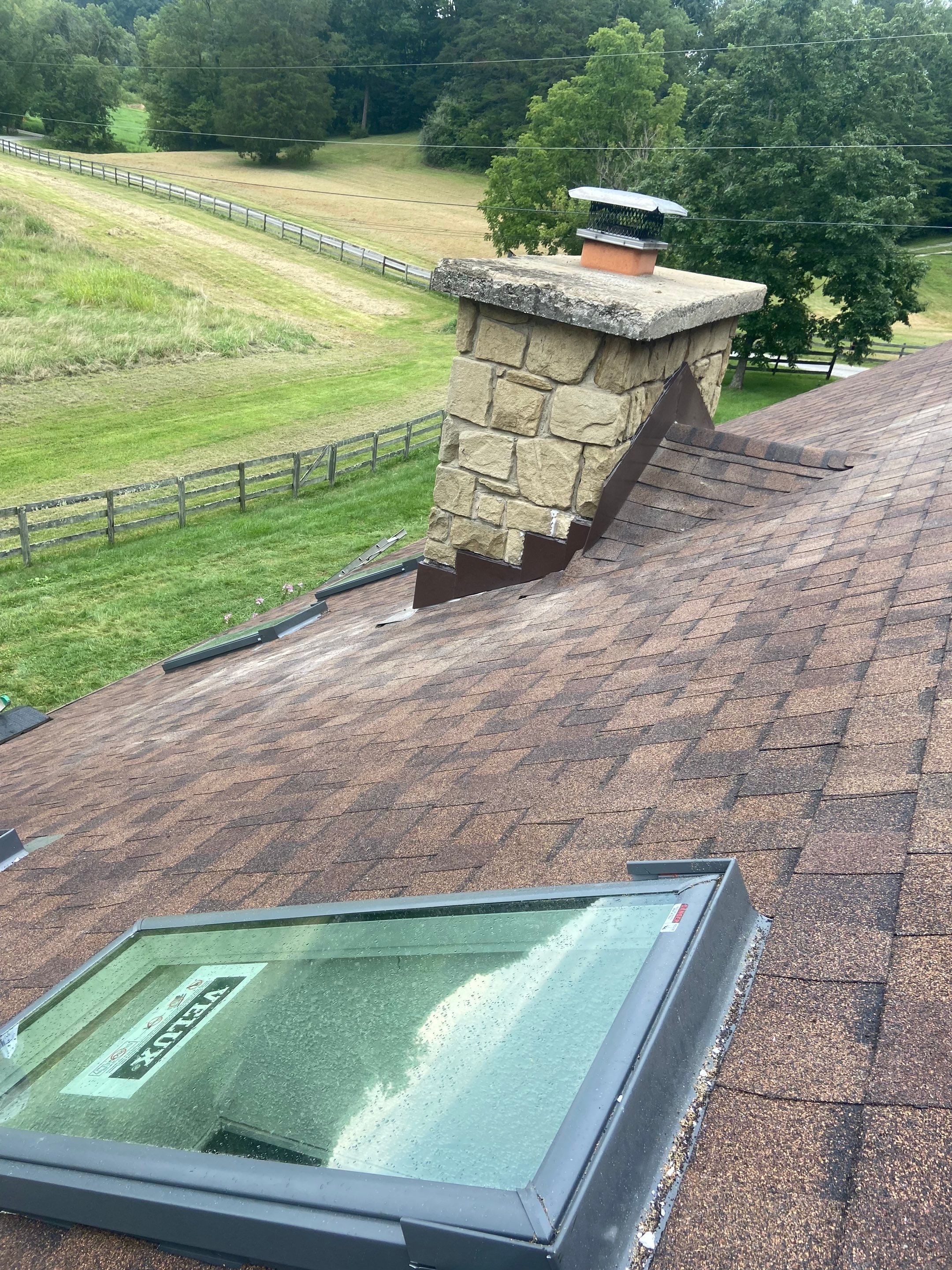 Shingle Roofing with Velux Skylight replacement and stone chimney flashing by Secure Construction Company Inc