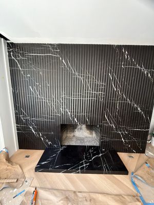 Full-Height Fluted Marble Fireplace Wall