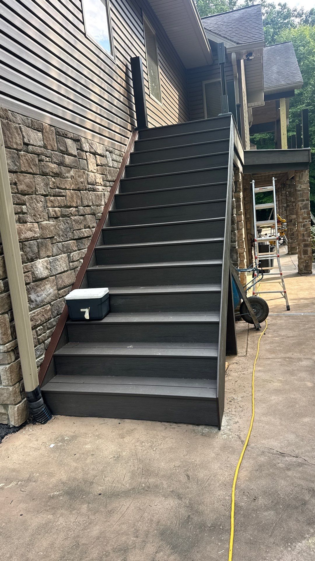Custom Composite Deck Construction with Stone Pillars in Fayetteville by Walnut Hollow Decks & Outdoor Living
