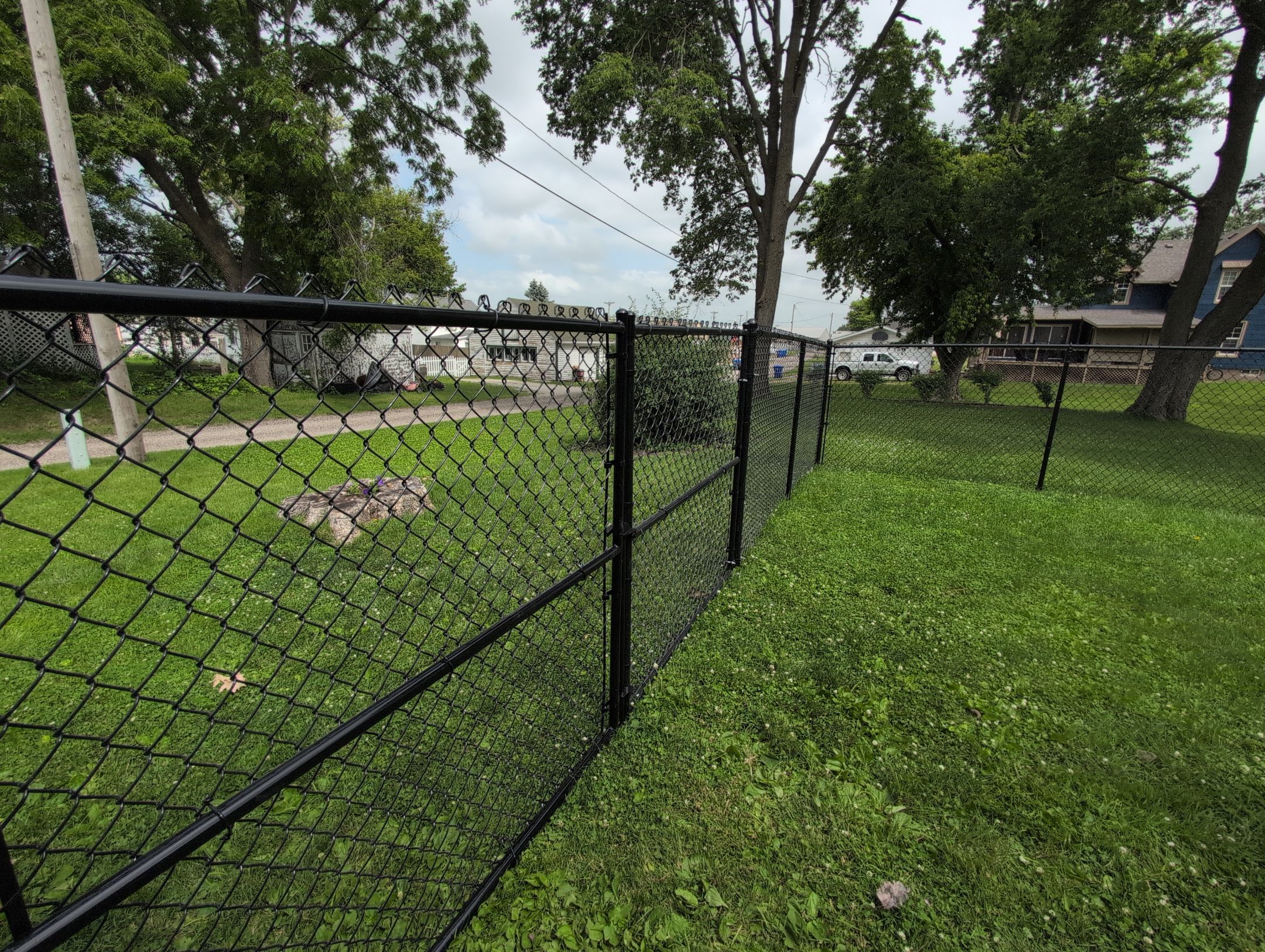 Black Vinyl Coated Chain Link Fence Installation in Independence by Perfect Picket Fence and Stain