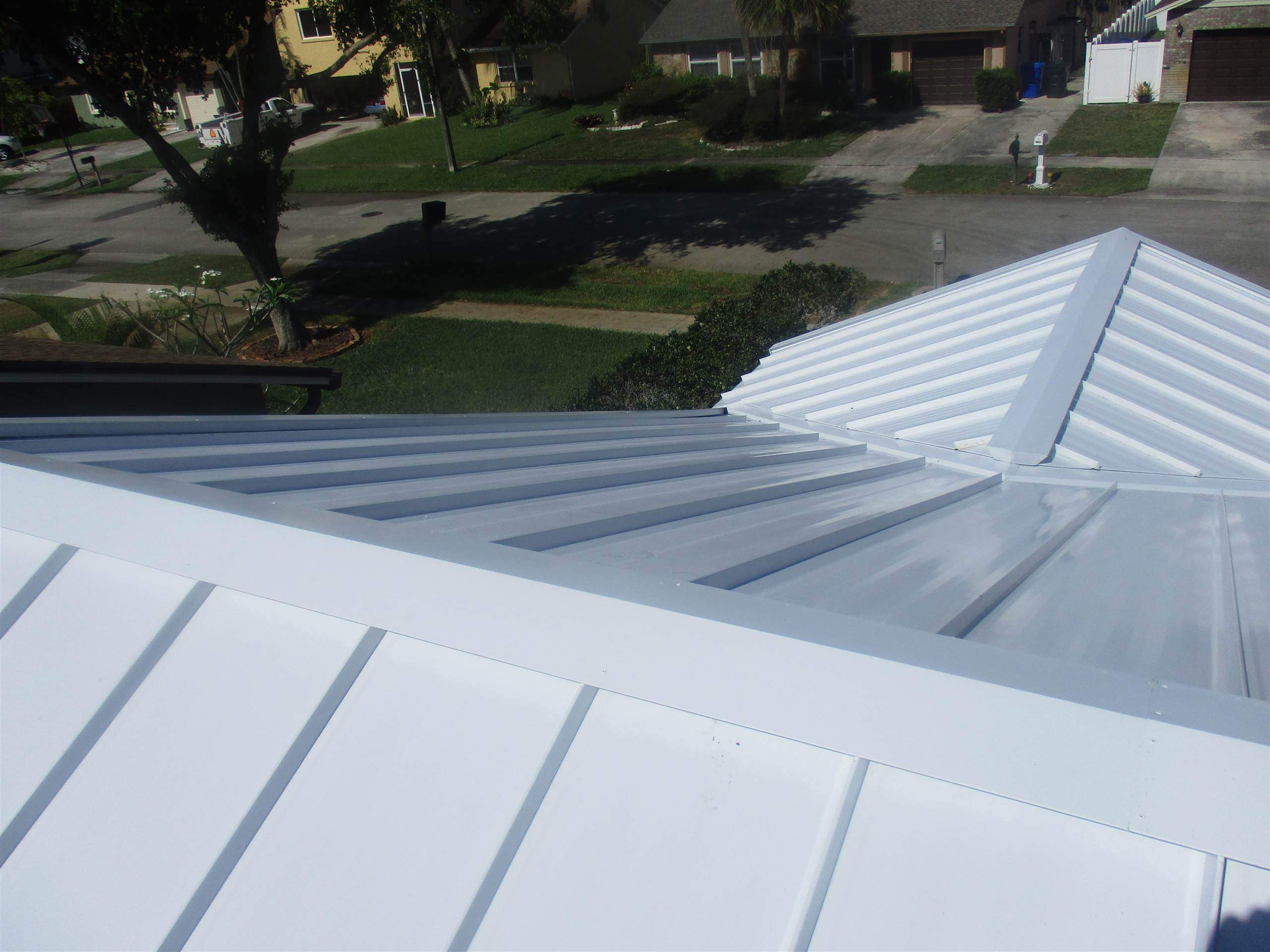 Standing Seam Metal & Flat Re-Roof using 1.5" Nail Strip 24ga Solar White Kynar Coated Standing Seam Metal Panels by Morton Roofing, Inc.