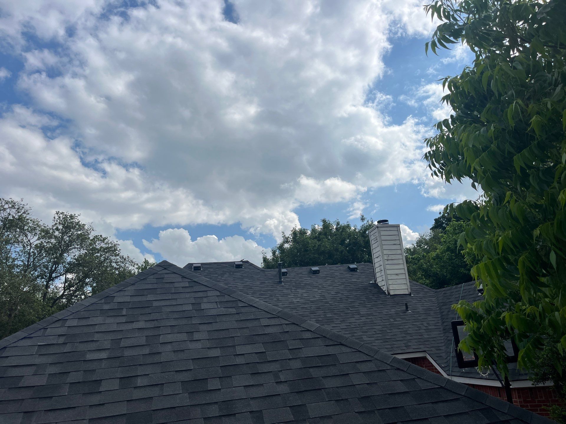 Red brick with Malarkey Midnight Black  by Tejas Roofworks + Restoration