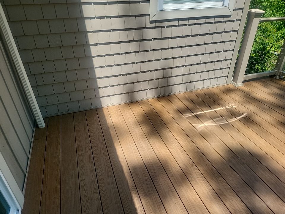 Deck installation using cable railing. by Burke Home Services