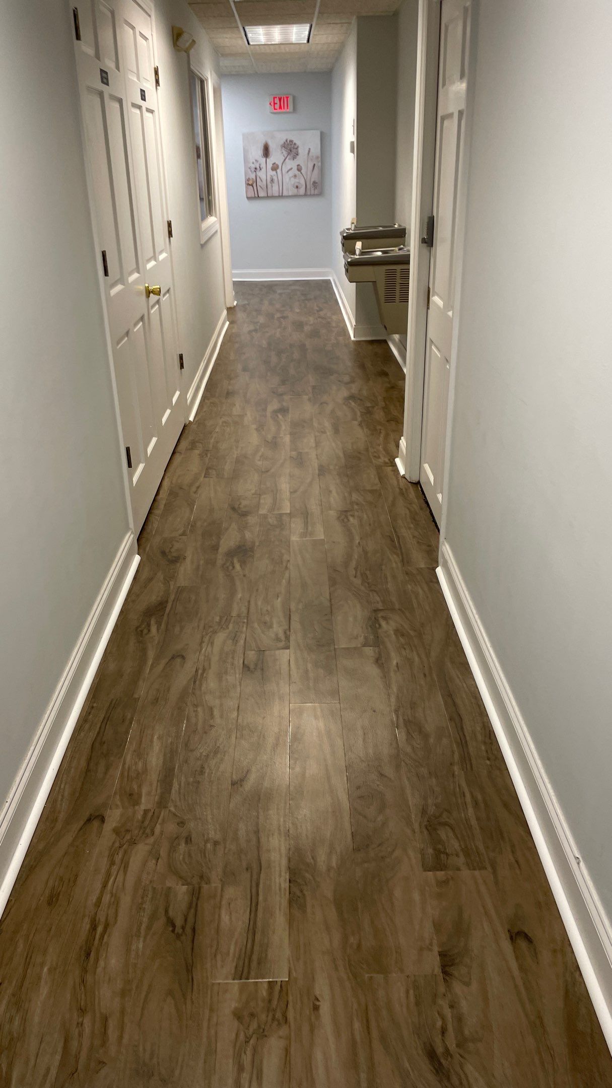 Office Remodel from Worn Out Carpet to Sleek Glued Down LVP by Footprints Floors of Coastal Carolina