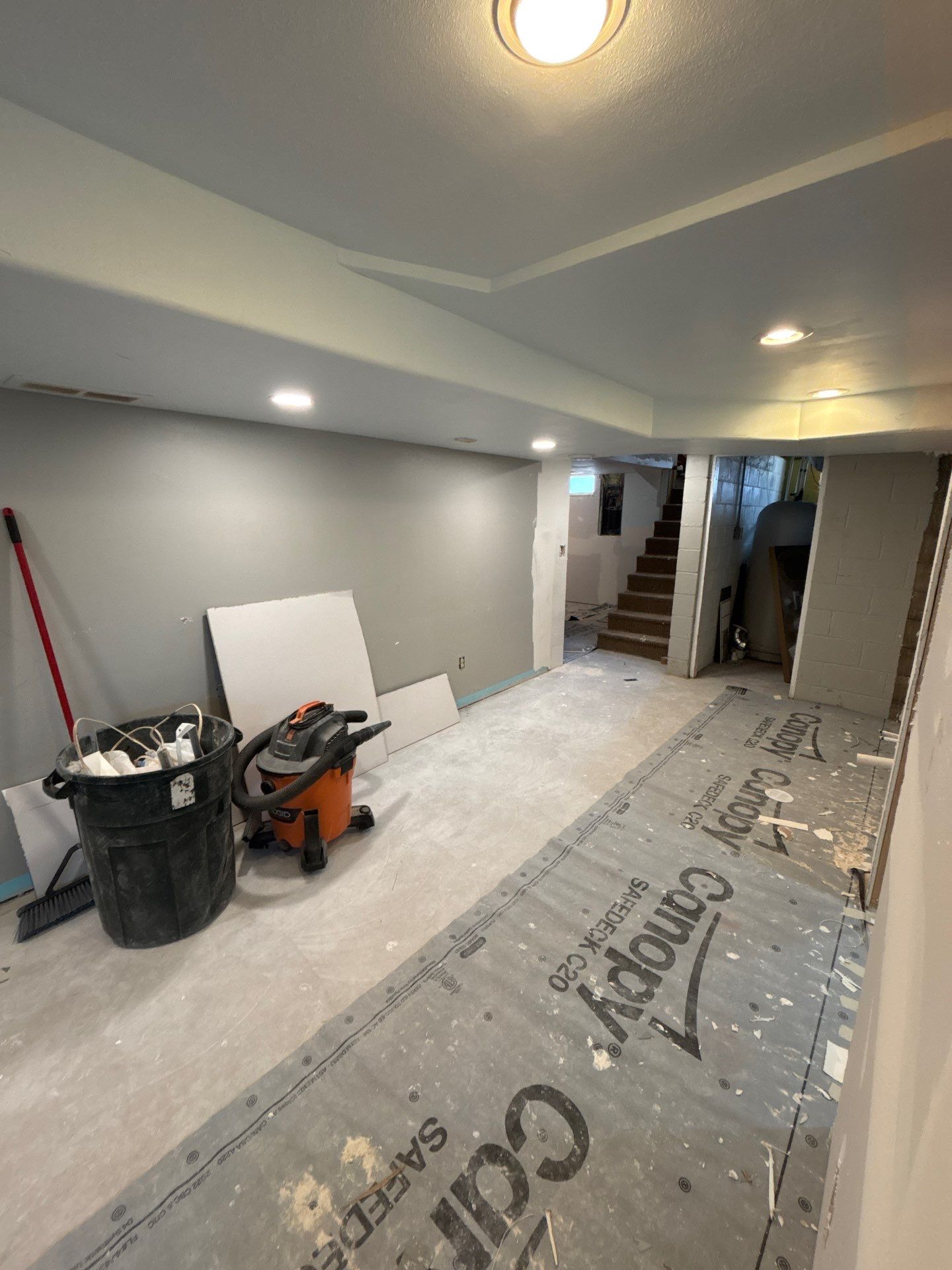 High-Gloss Epoxy Floor Coating and Basement Renovation in Rock Rapids by Select Painting, Coatings & Garage Cabinets