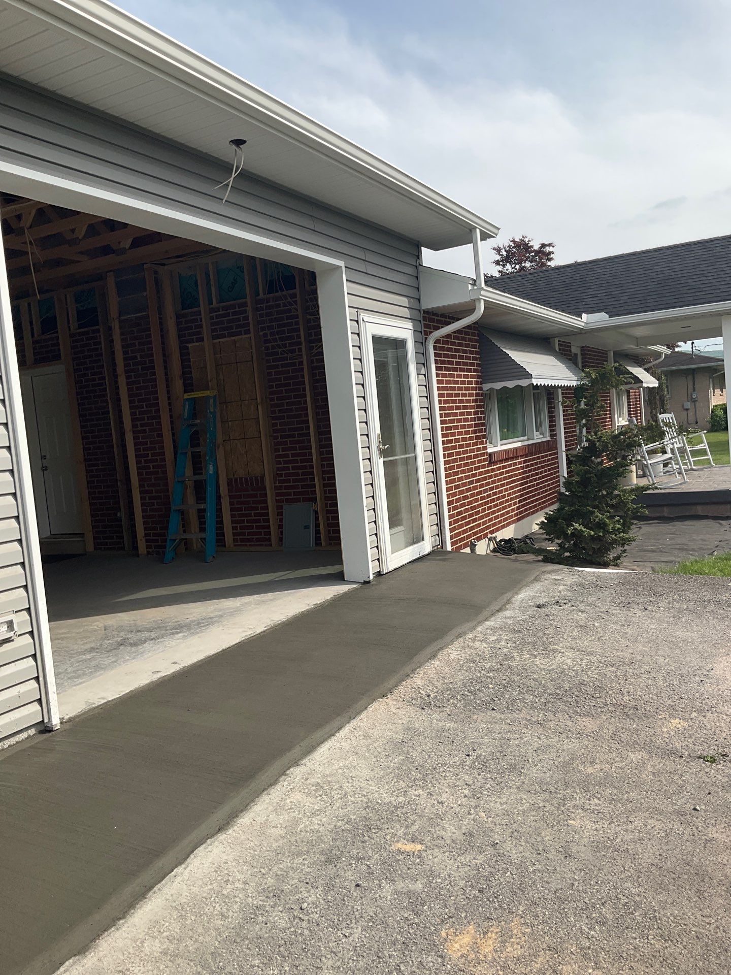 Tower City Residential Addition Featuring Gray Vinyl Siding and Garage by Esh Builders