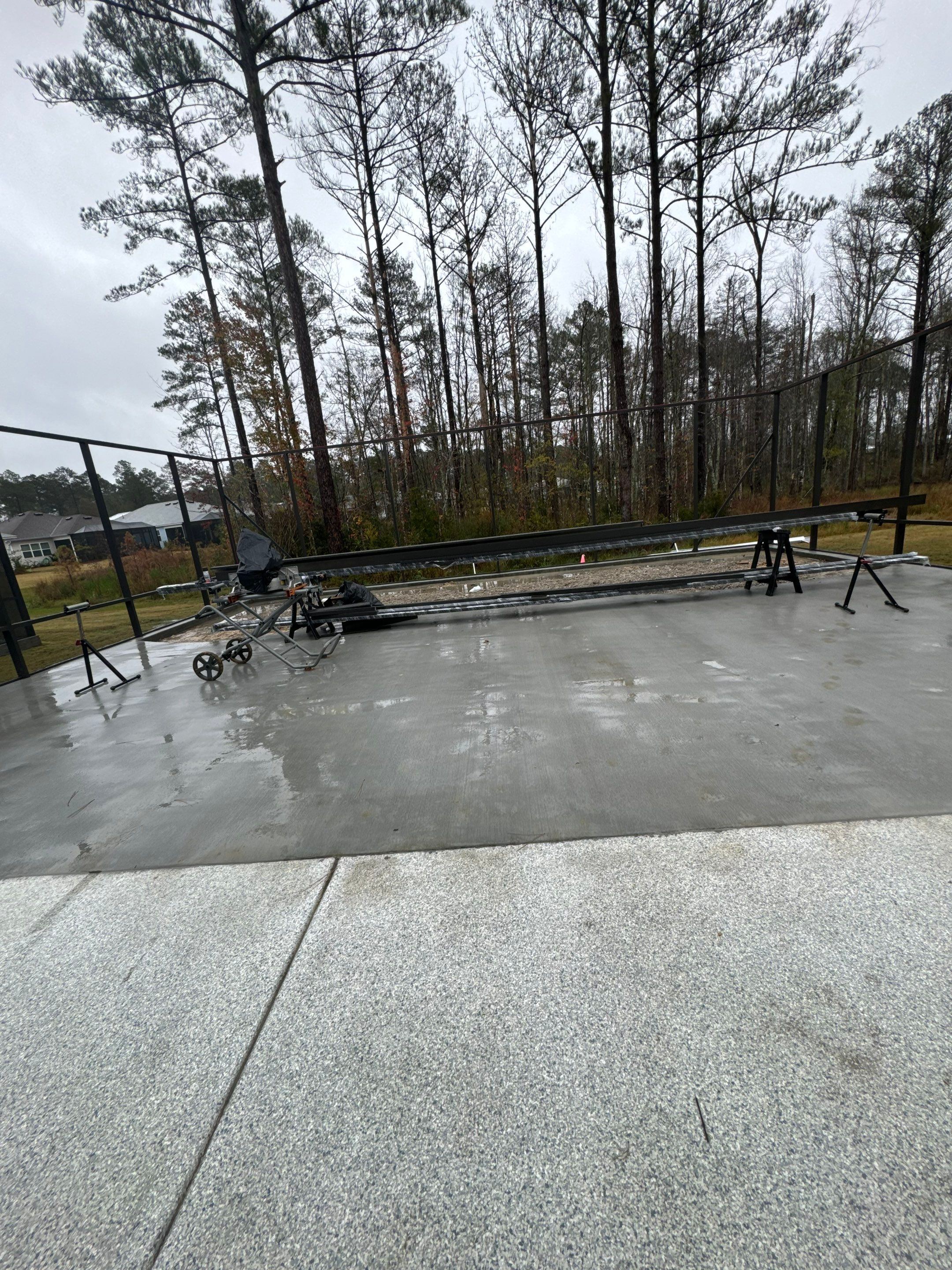 Hardeeville Screened-In Concrete Patio and Integrated Artificial Turf by Lowcountry Scapes, LLC