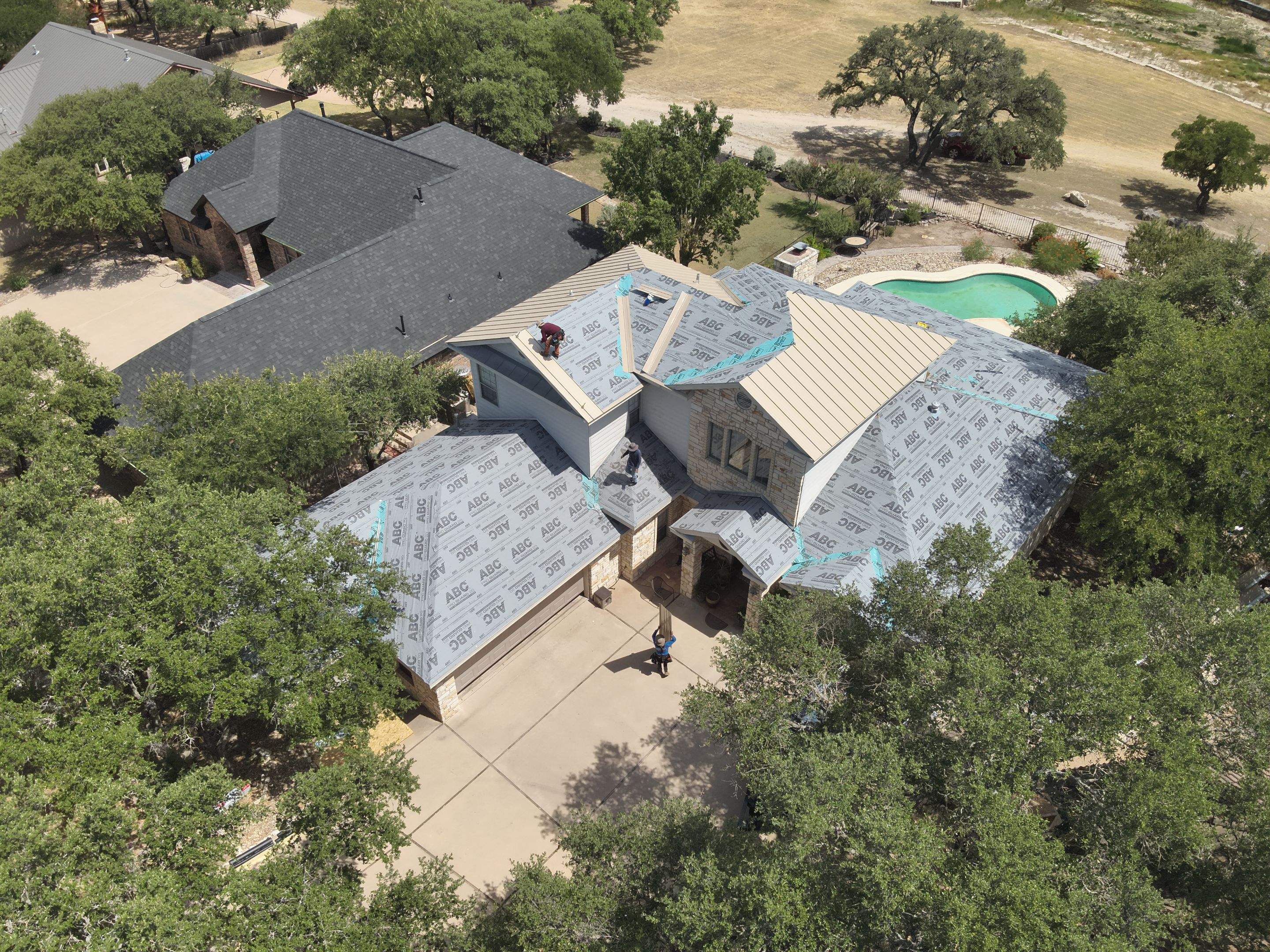 Residential Roof Replacement using 24 GA Double-Lock - Surrey Beige by Action Exteriors Austin