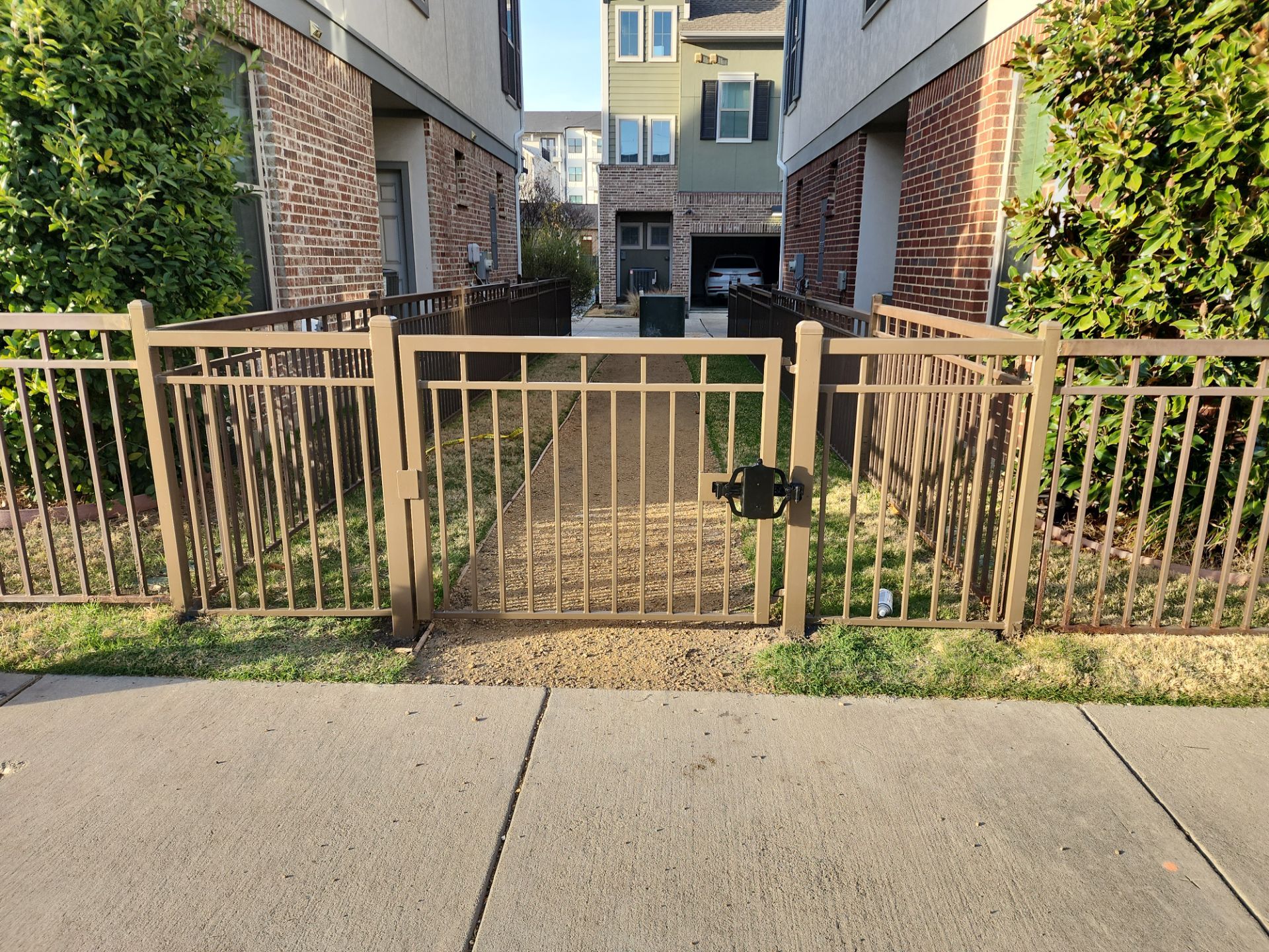Arbor with Wrought Iron Fencing by 3:16 Roofing and Construction
