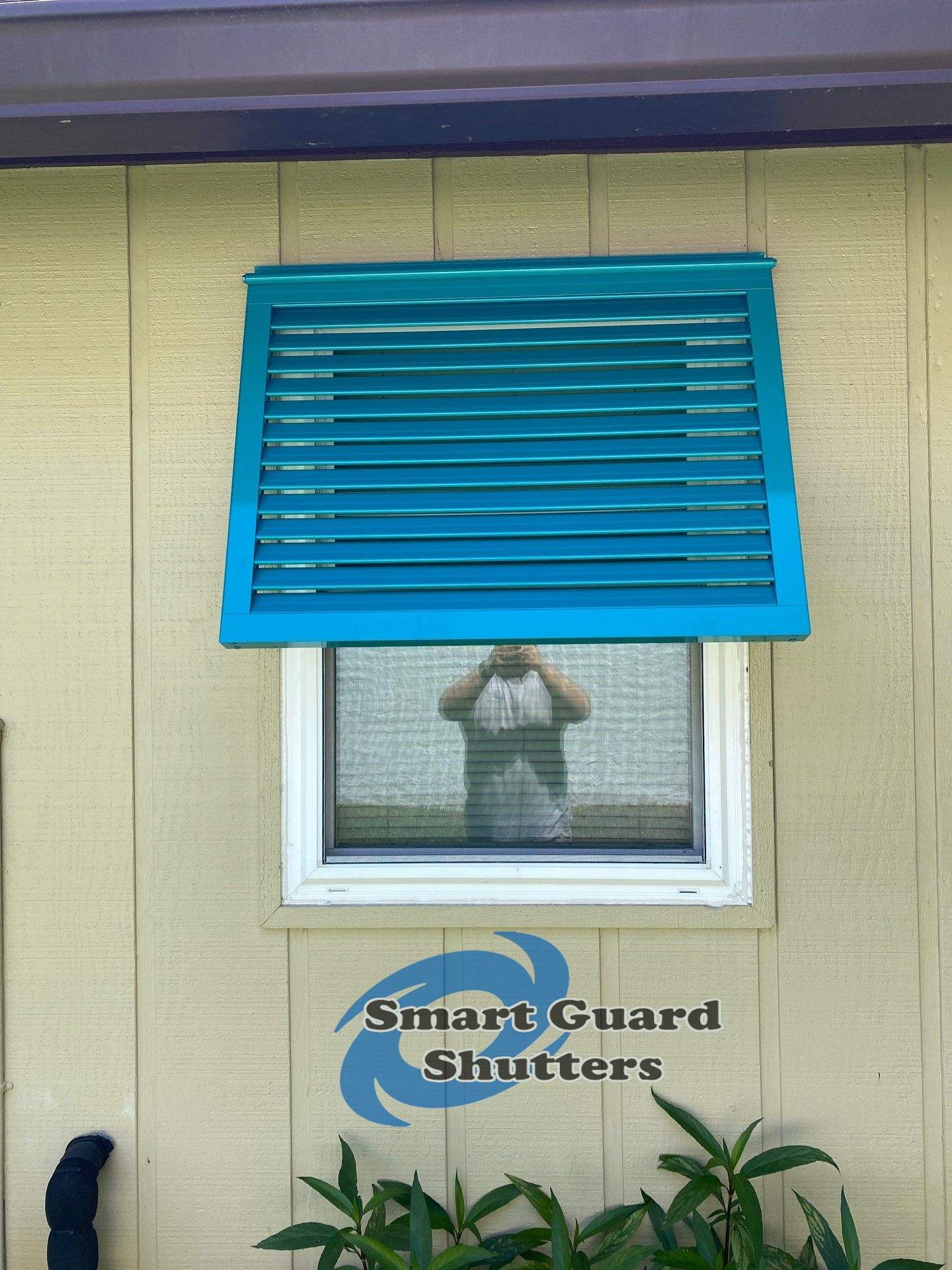 Decorative Bahama Shutters in Turquoise Blue  by Smart Guard Shutters