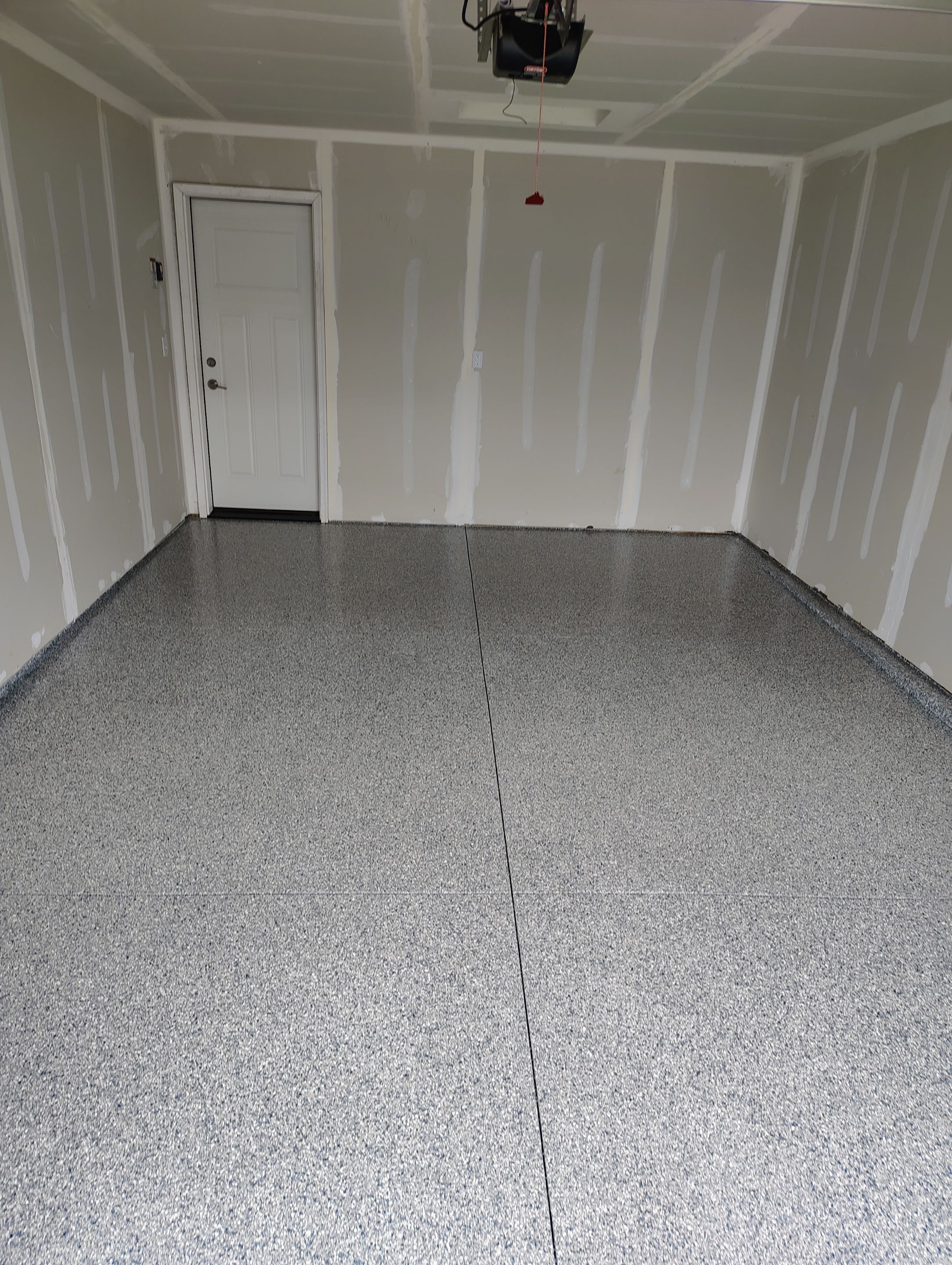Custom Epoxy Garage Floor Coating Installation in Sioux Falls by Select Painting, Coatings & Garage Cabinets