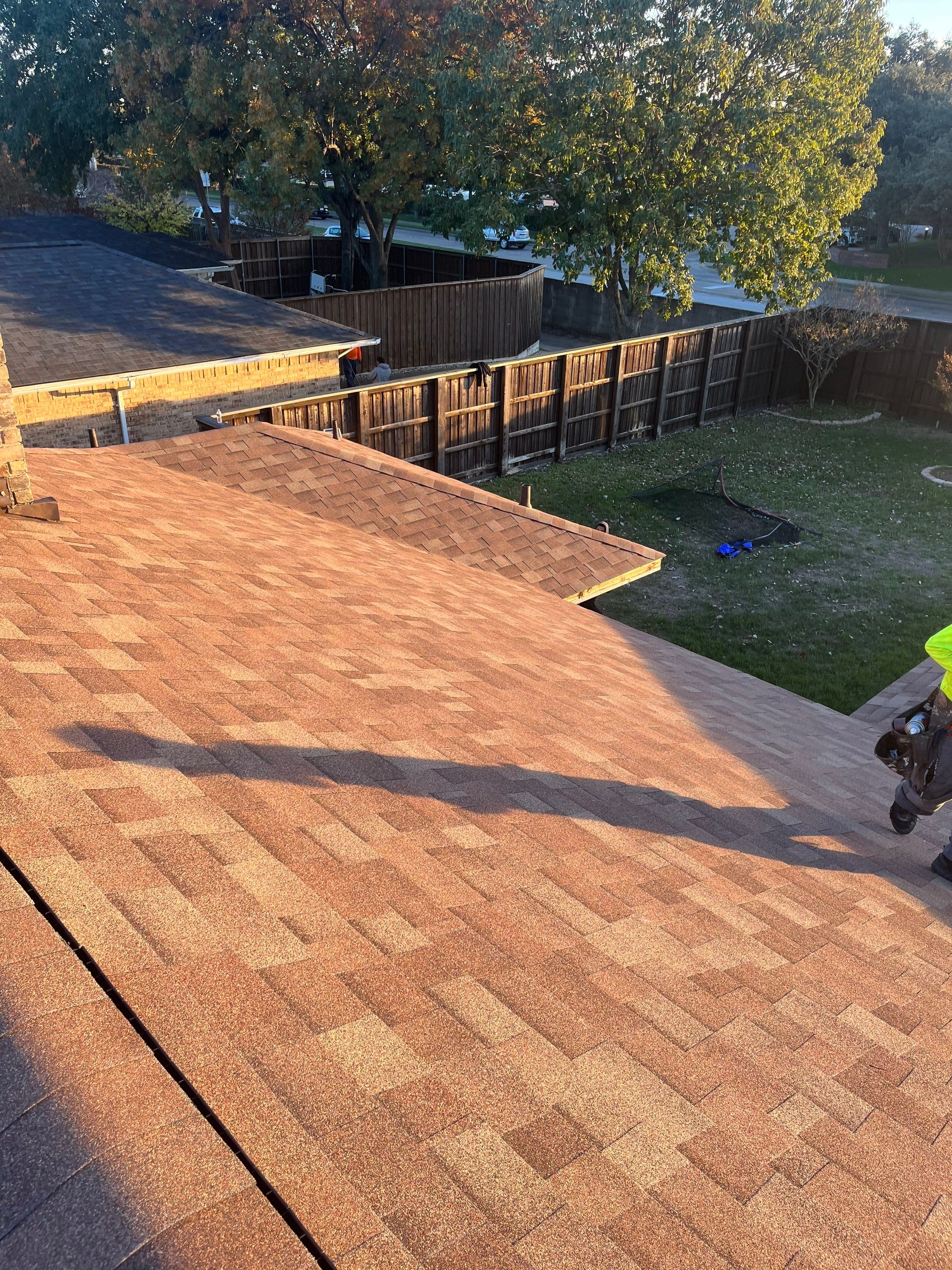 Brick with white area around windows with Malarkey Sienna Blend by Tejas Roofworks + Restoration