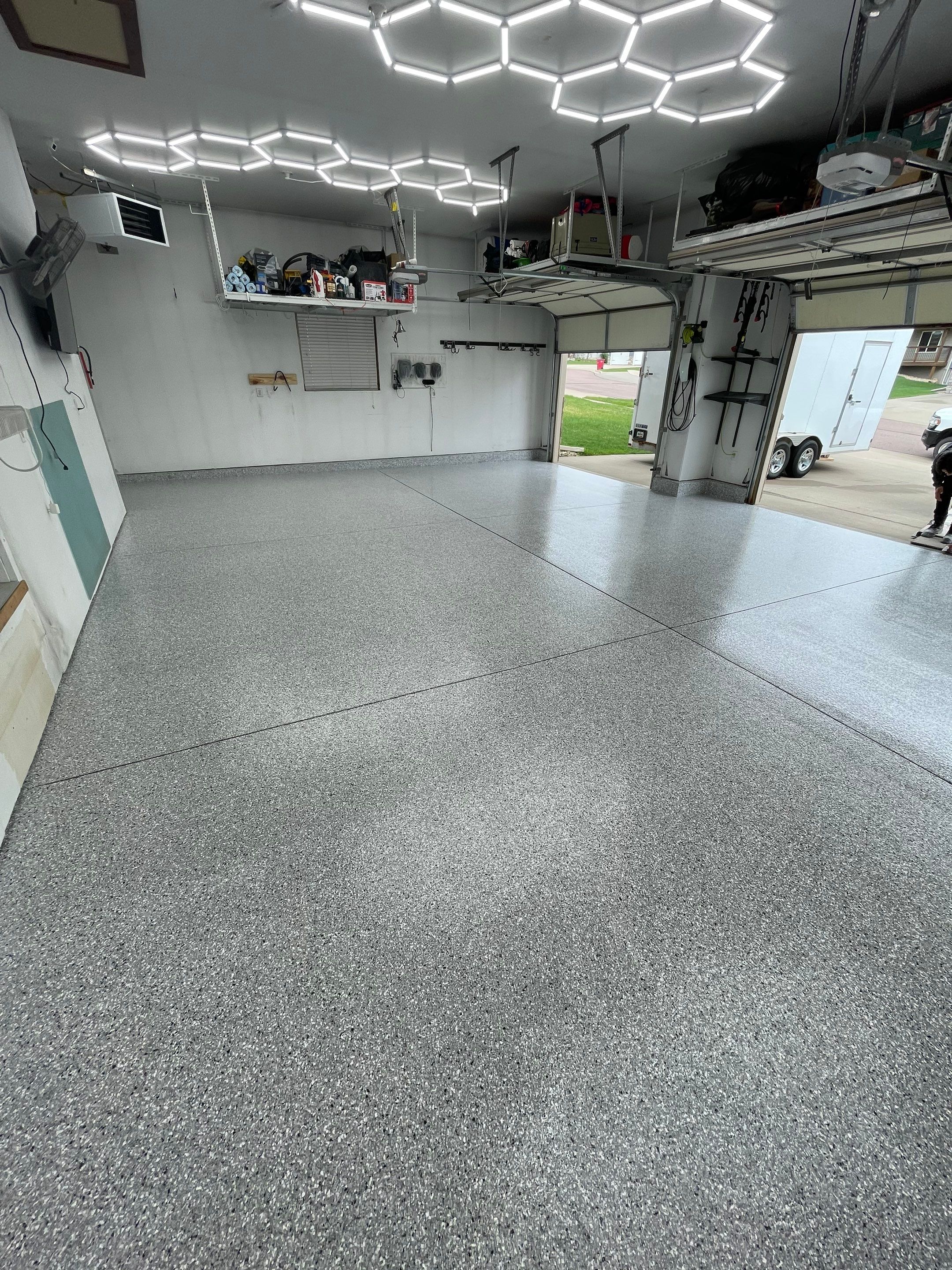 Feather Gray Epoxy Floor Coating Installation in Sioux Falls by Select Painting, Coatings & Garage Cabinets