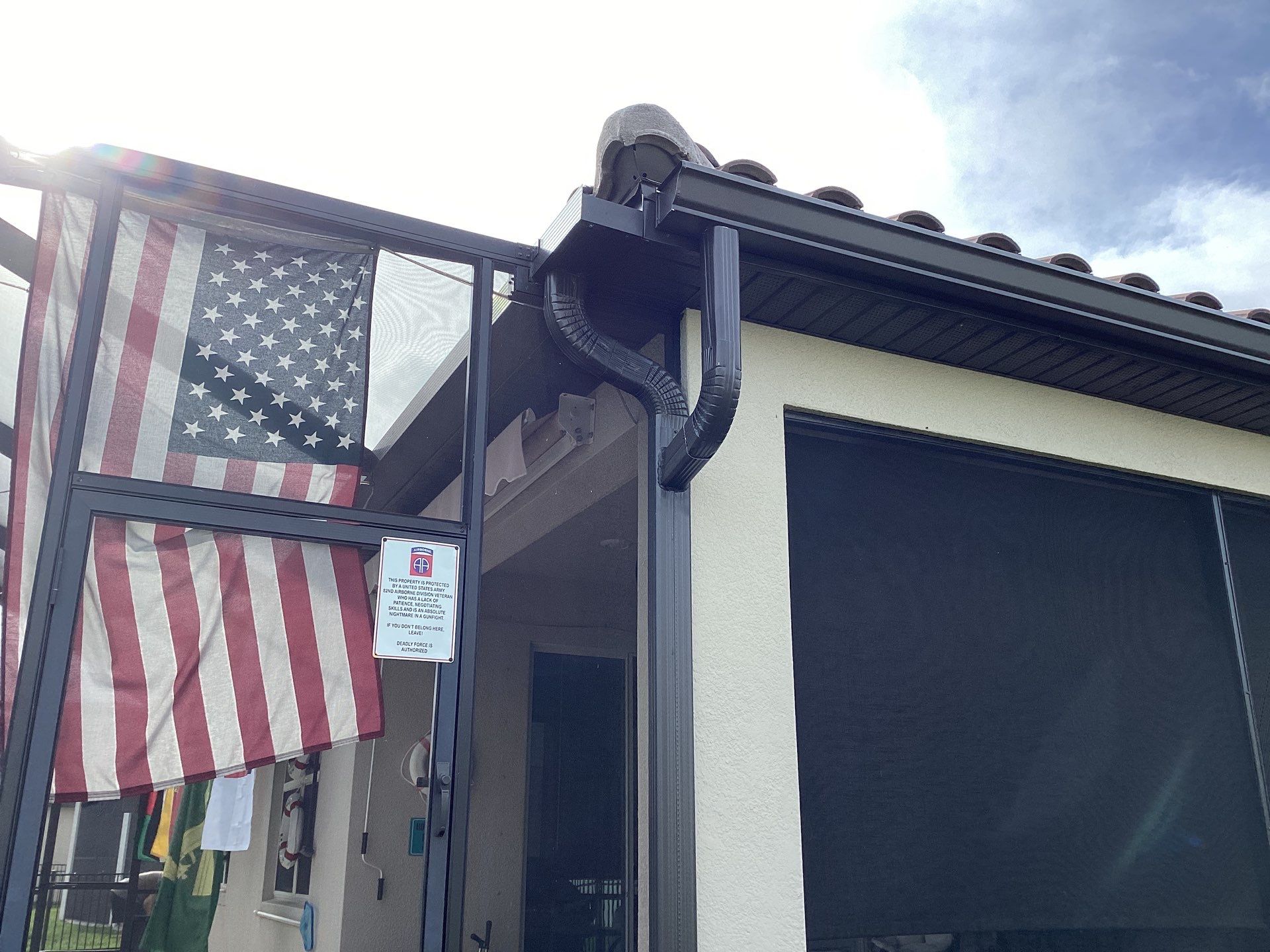 Musket brown seamless gutters with splash guards, new downspouts, and extensions in Bradenton, FL by Gutter Professors