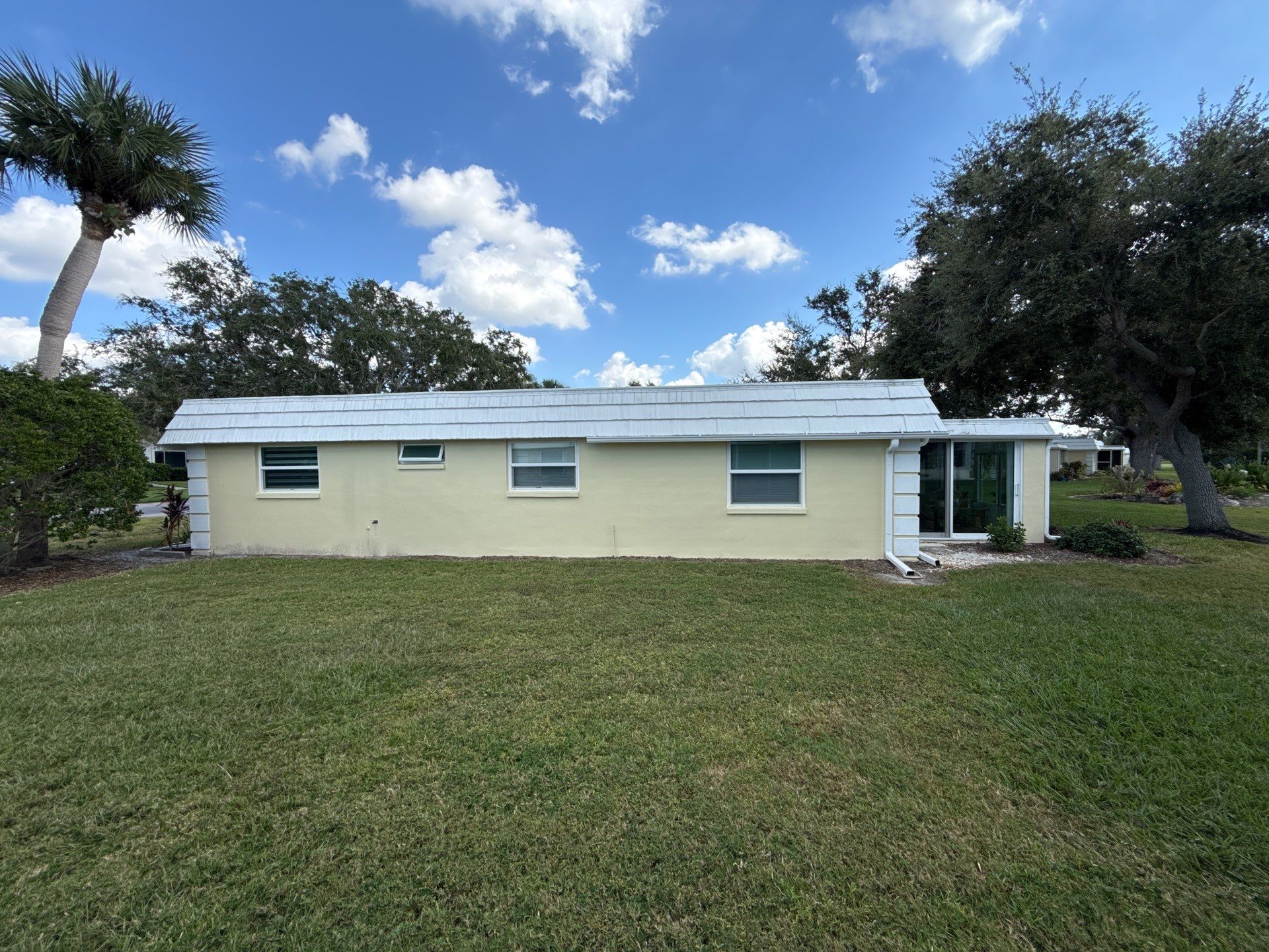 White Gutters and Matching Downspouts in Sarasota FL by Gutter Professors
