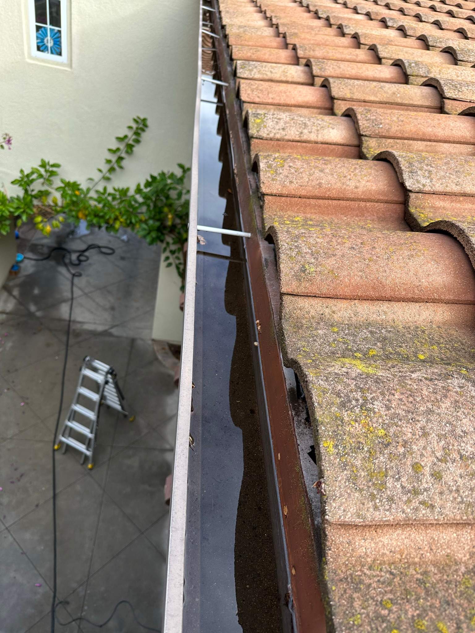 Clogged gutters at this Irvine home in Woodbury by Property Cleaning Experts, LLC