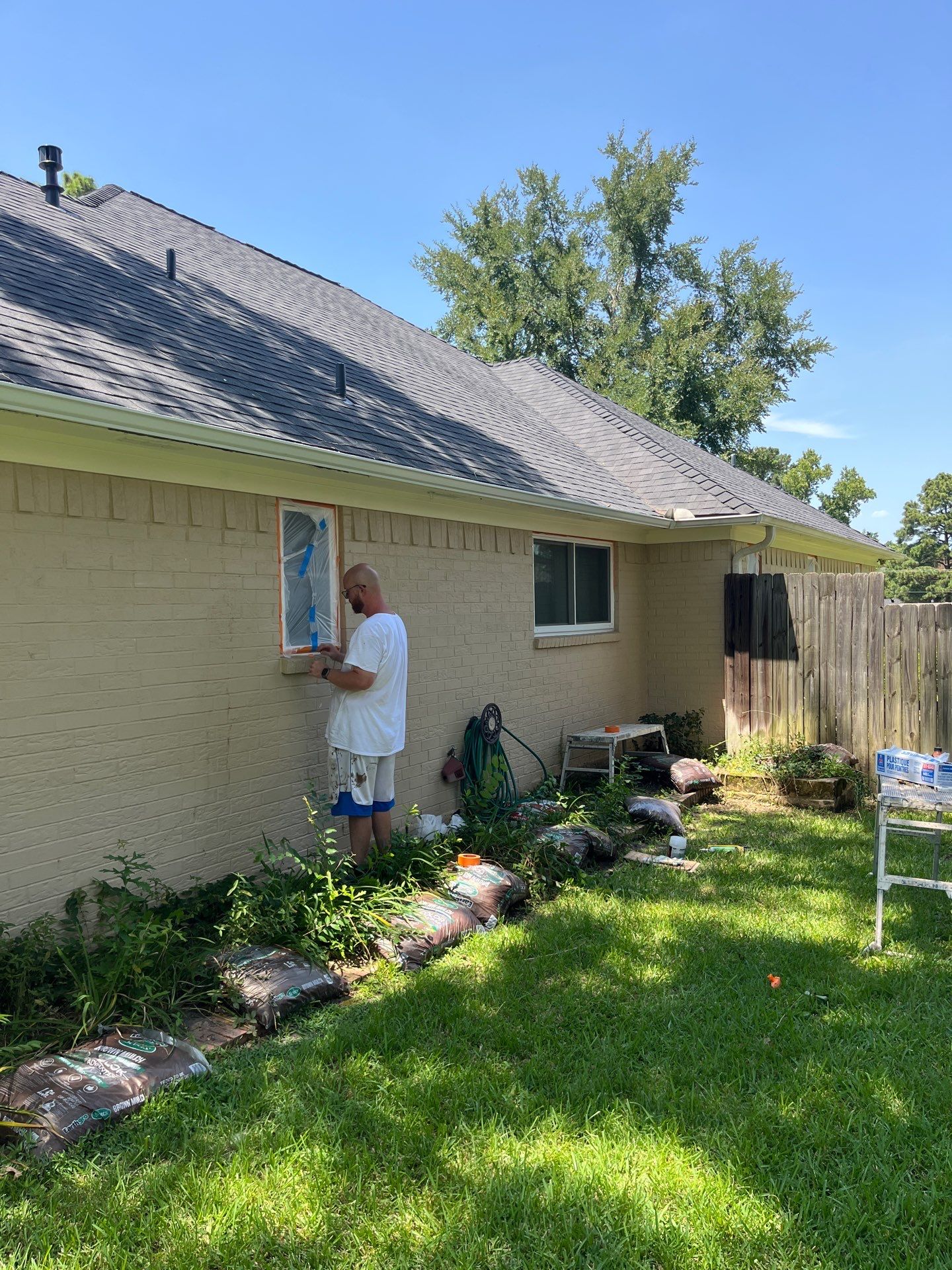 Exterior Painting in Tyler, TX | Brick House with White & Blue Finish by Quality Coats Painting