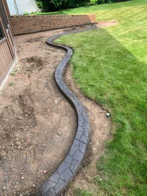 Decorative Stamped Concrete Garden Border Installation in Medicine Hat by Pump it Up Concrete Jacking