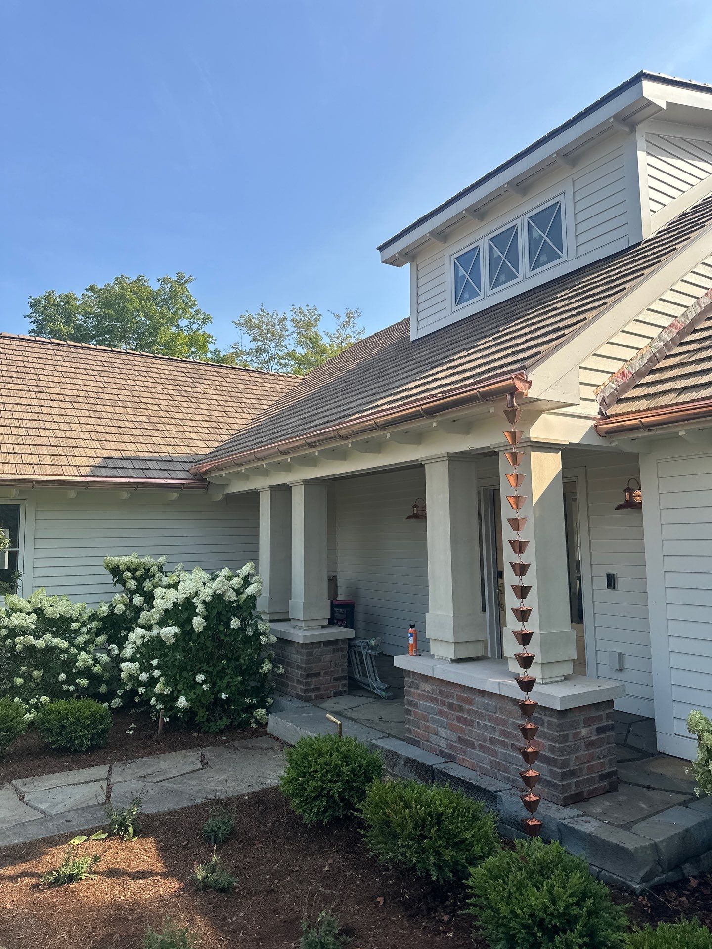 Custom Copper Gutter System and Accent Roofing in East Jordan by Rainbow Seamless Systems