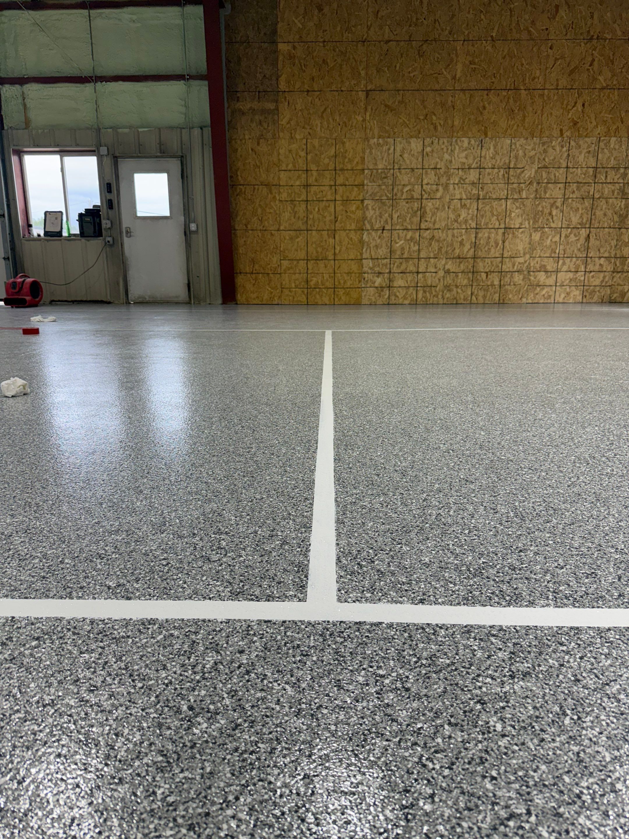 Custom Polyurea Shop Floor with Basketball Court Lines in Rock Valley by Select Painting, Coatings & Garage Cabinets