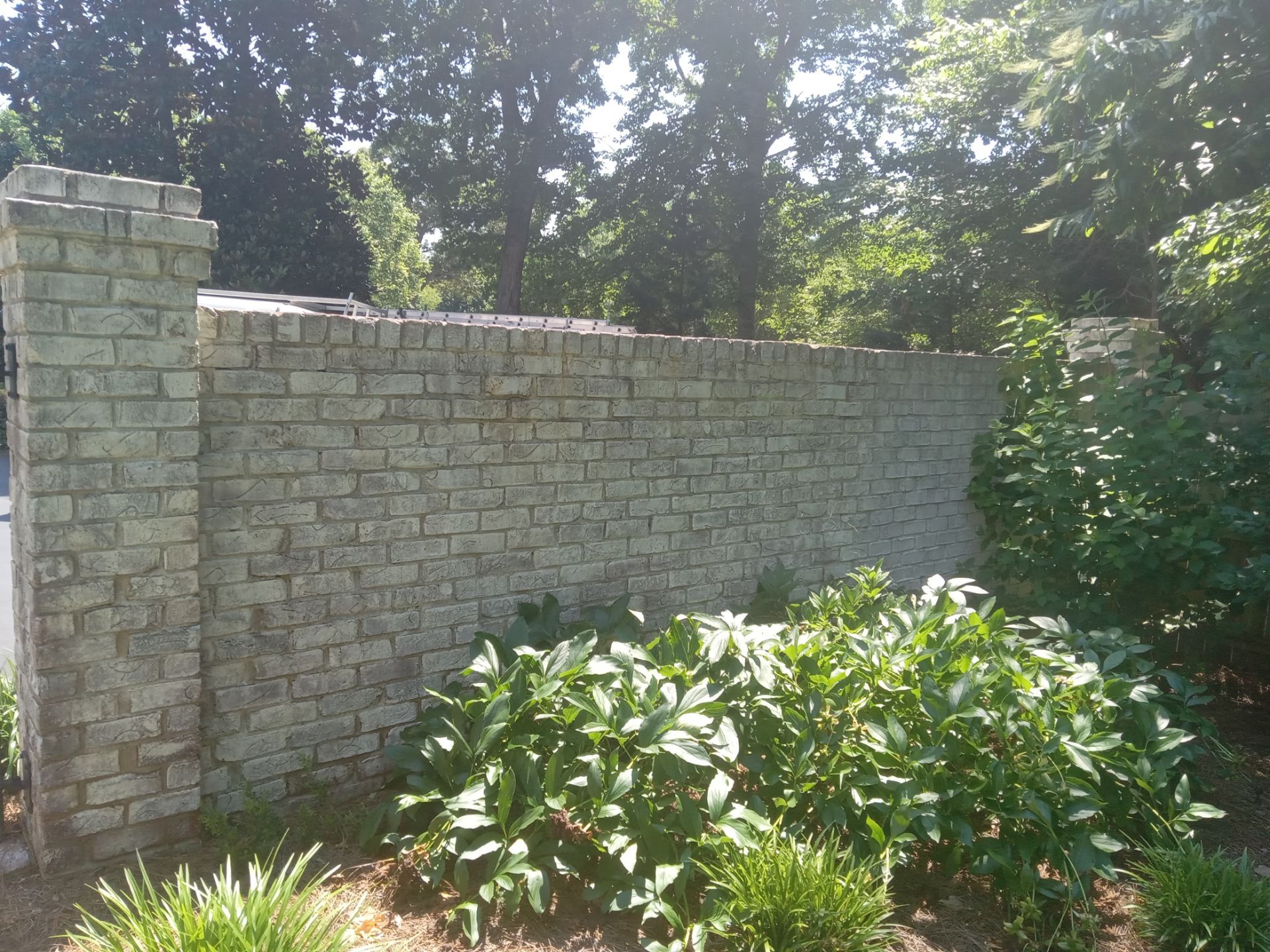 pressure washing stone brick wall removing dirt build-up restoring surface appearance